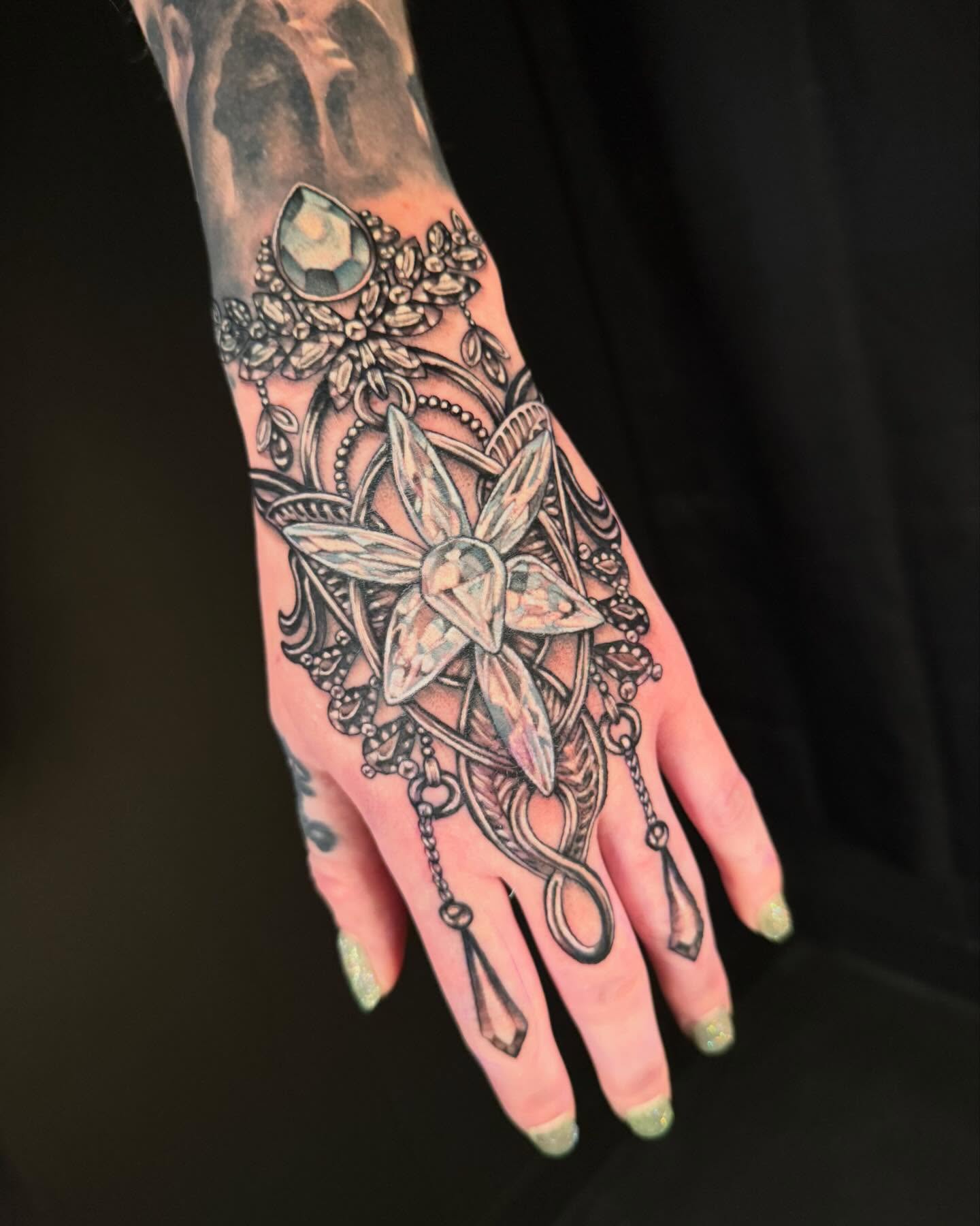 Jeweled floral mandala geometric tattoo on the hand by Jade Lewis