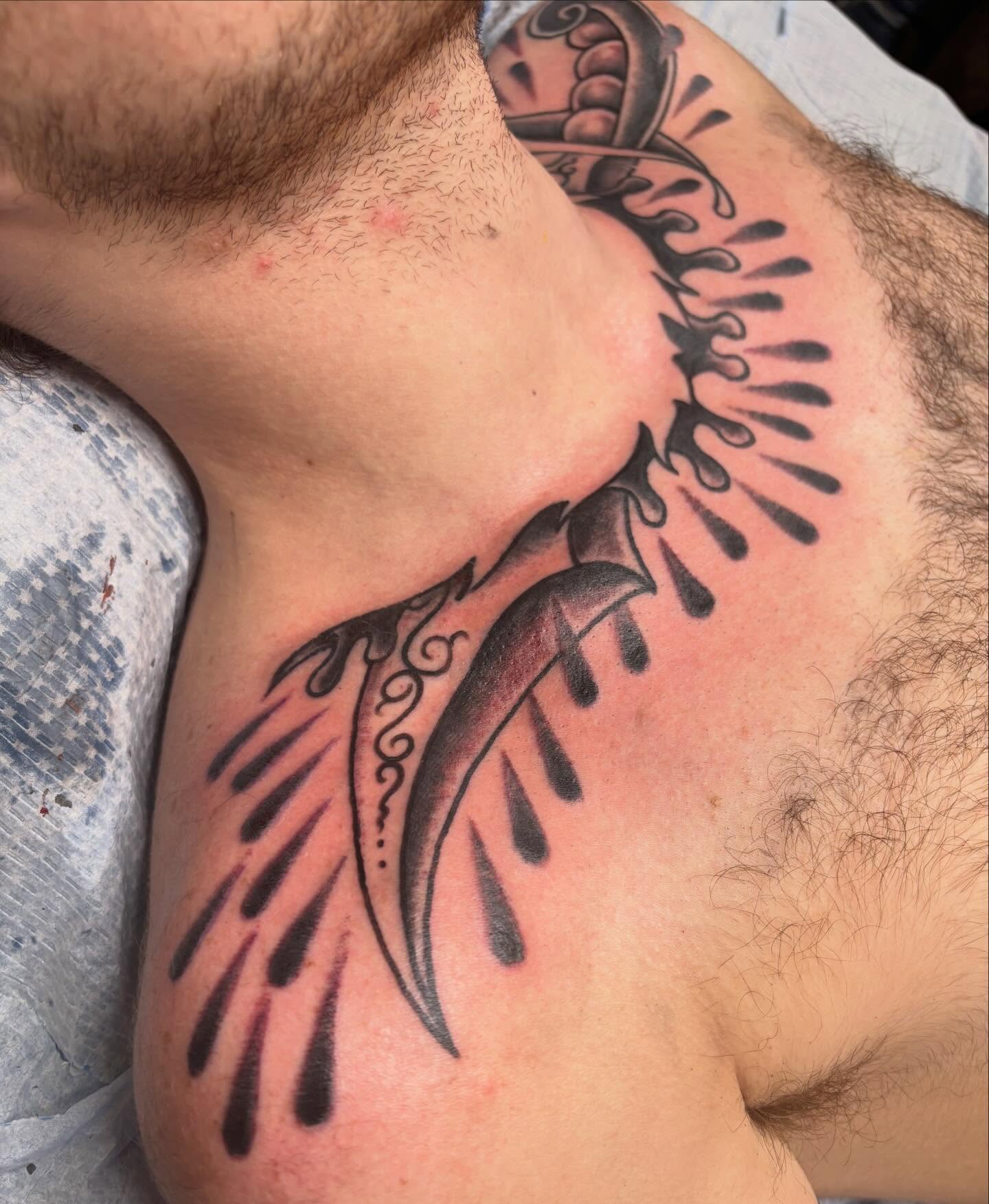 Feather black and grey tattoo on the shoulder by Steve Reid