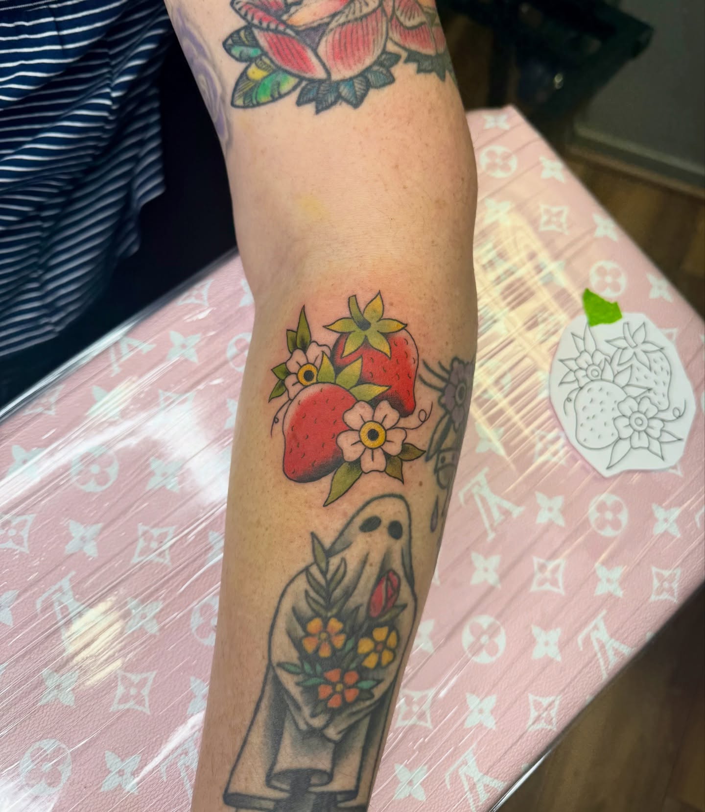 Strawberries and flowers American traditional tattoo on the forearm by Palmer Andrist🩸Fort Collins Tattoo Apprentice