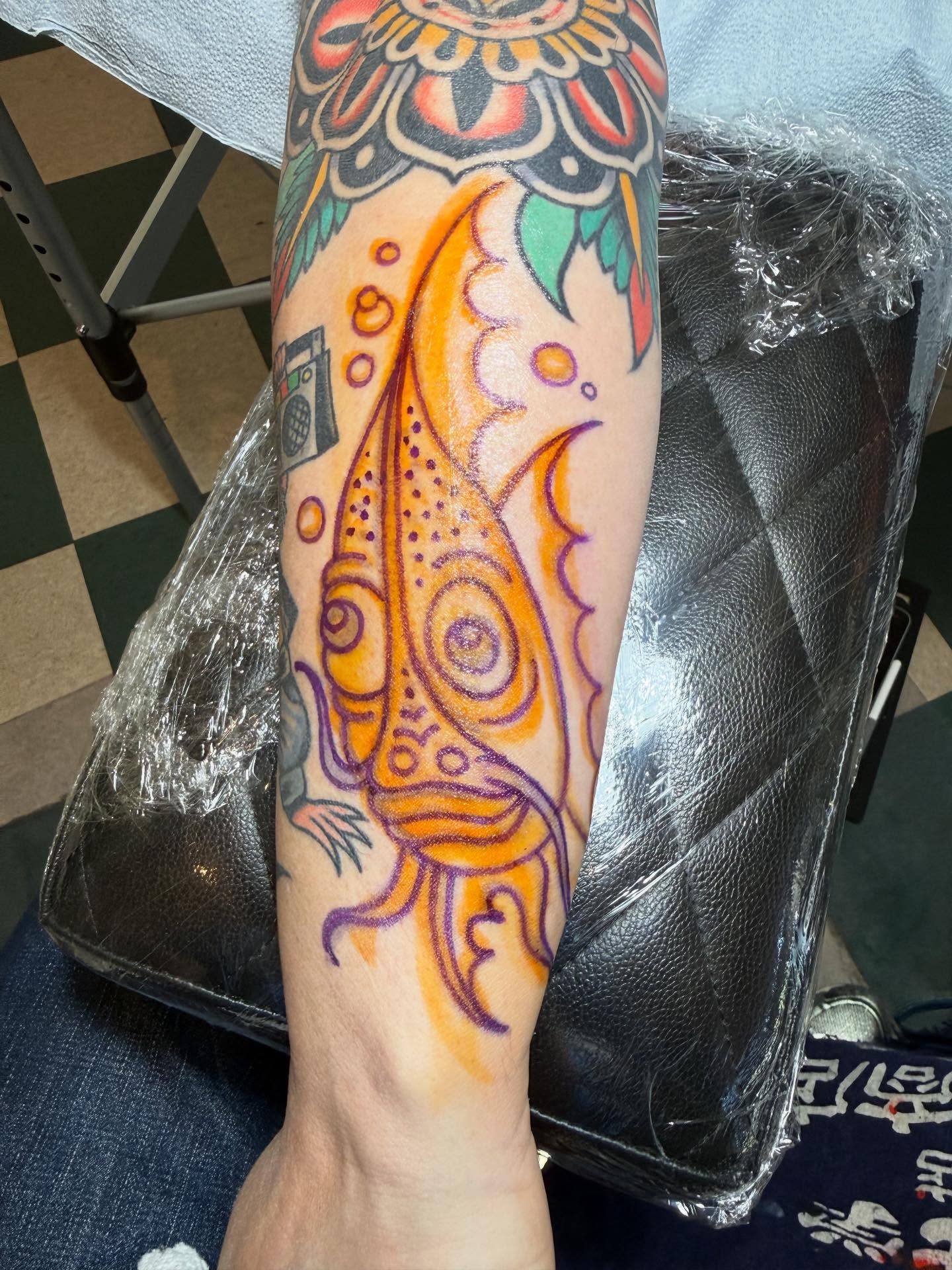 Peacock American traditional tattoo on the forearm by San Diego tattoo artist
