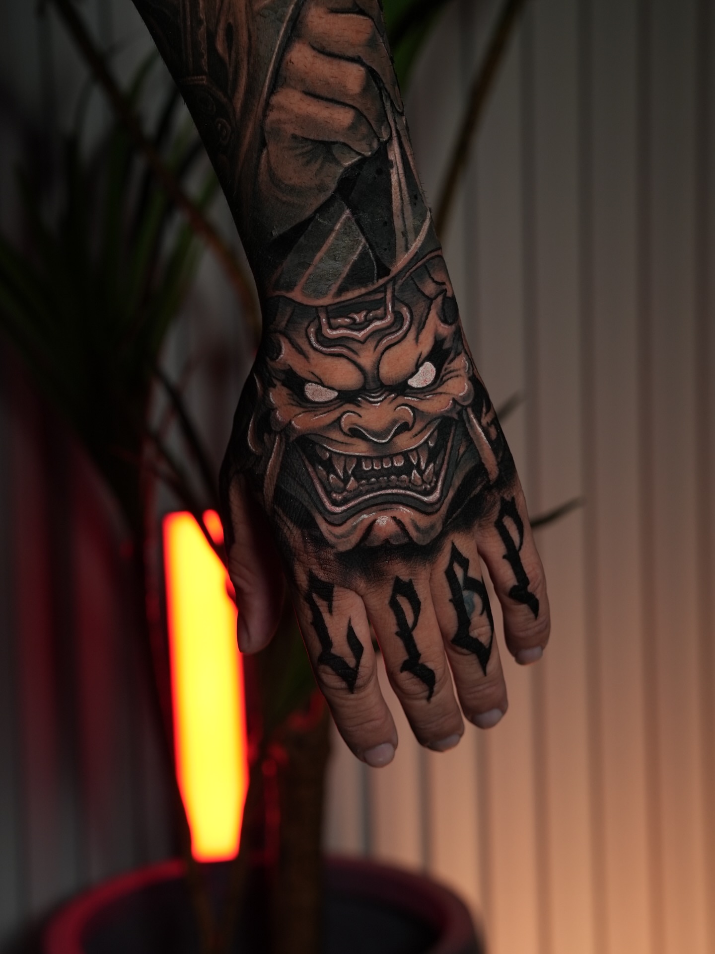Demon mask dark realism tattoo on the hand by Adrian Gonzalez