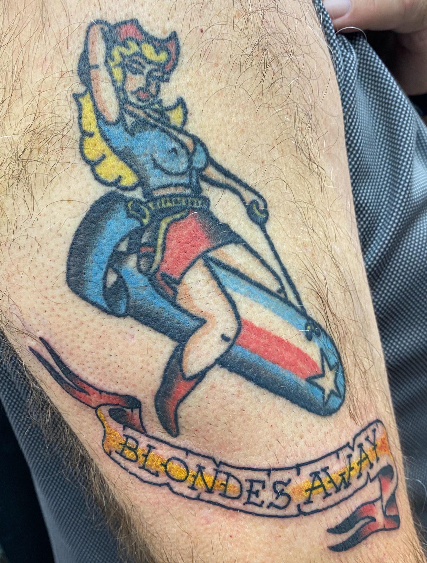 Blonde pin-up girl American traditional tattoo on the thigh by Mike Tapia