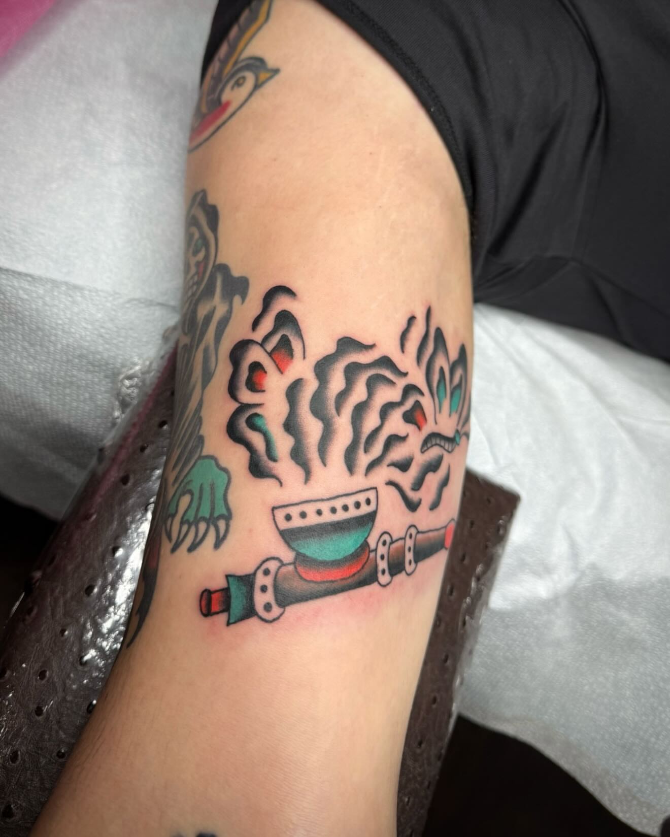 Smoke and pipe American traditional tattoo on the forearm by kalli berry