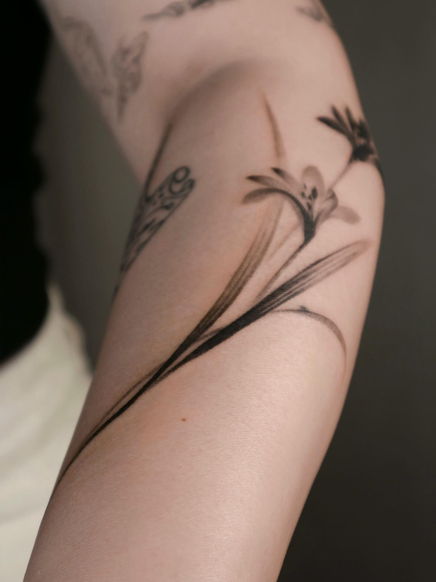 Lily black and grey tattoo on the forearm by River, New York, New York