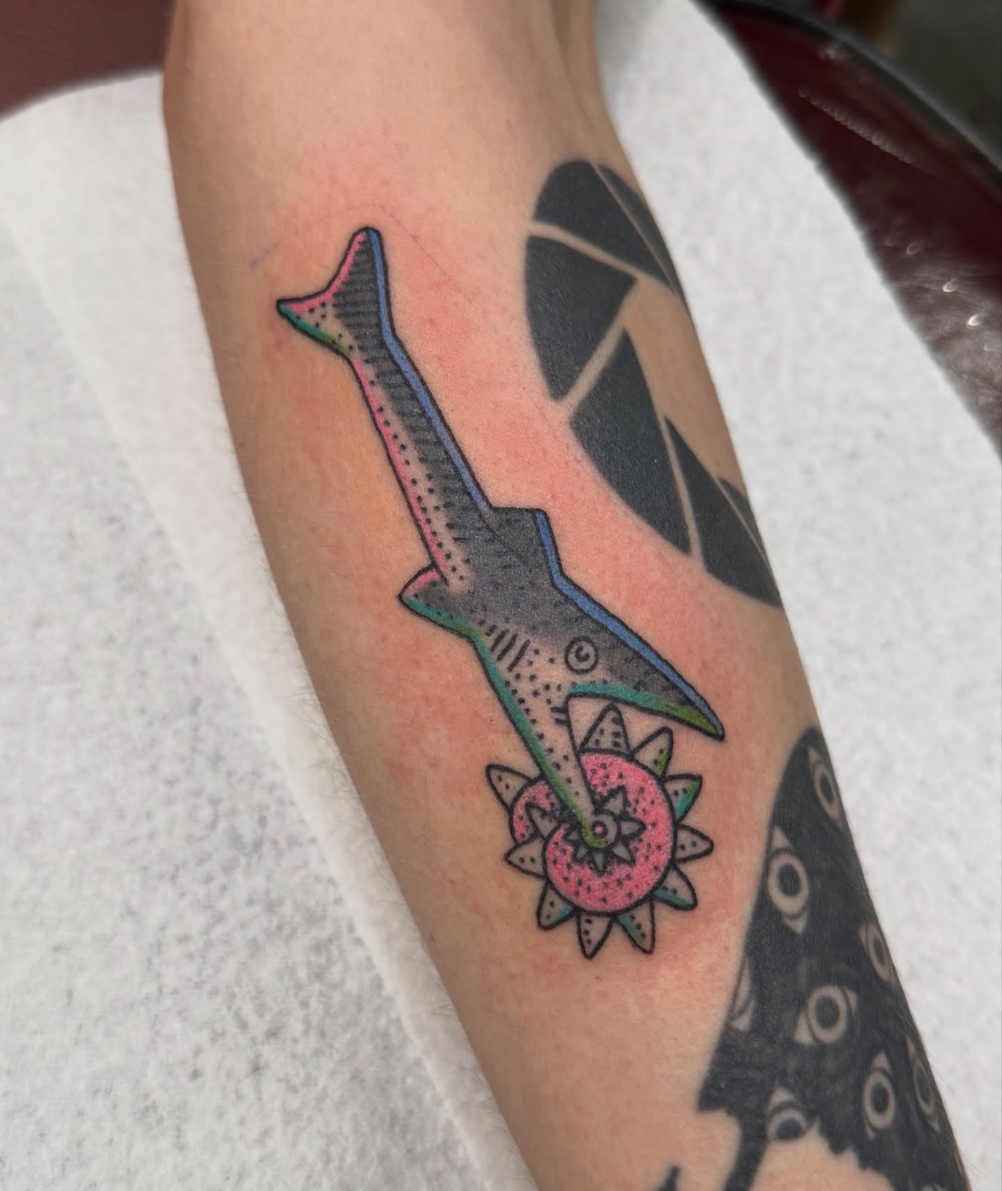 Shark with flower dotwork tattoo on the forearm by Sophie McTear