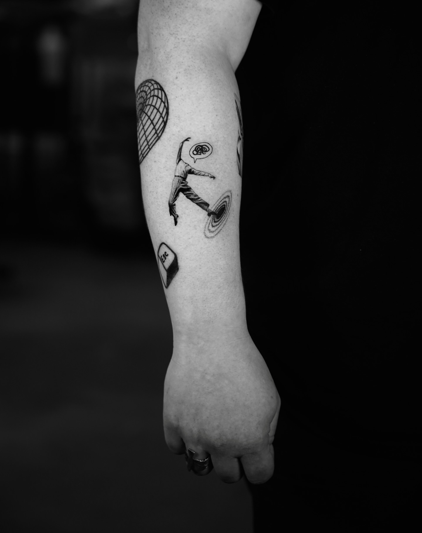 Abstract figure black and grey tattoo on the forearm by Metin Karaatli