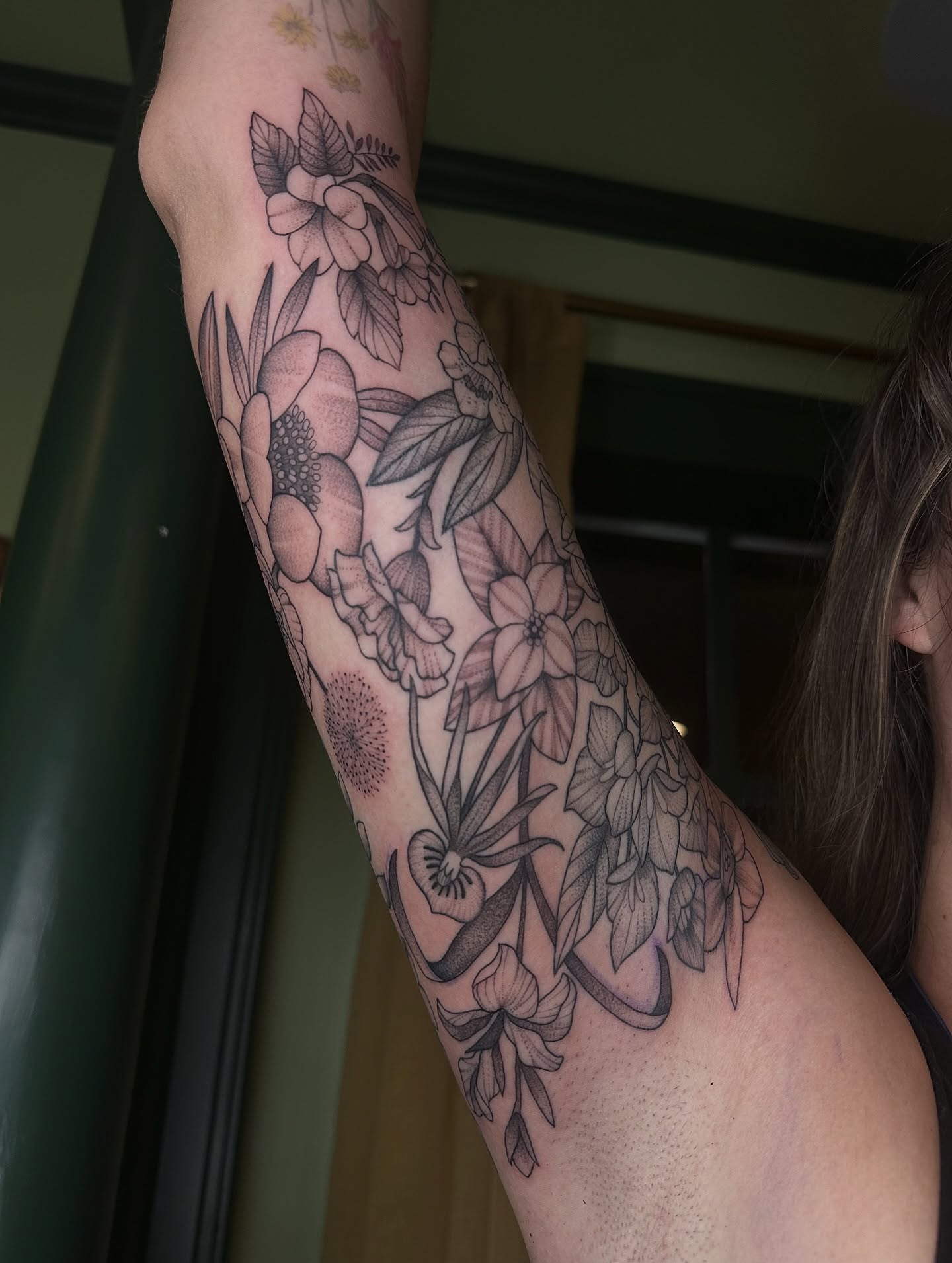 Floral bouquet black and grey tattoo on the forearm by Brieana Smith