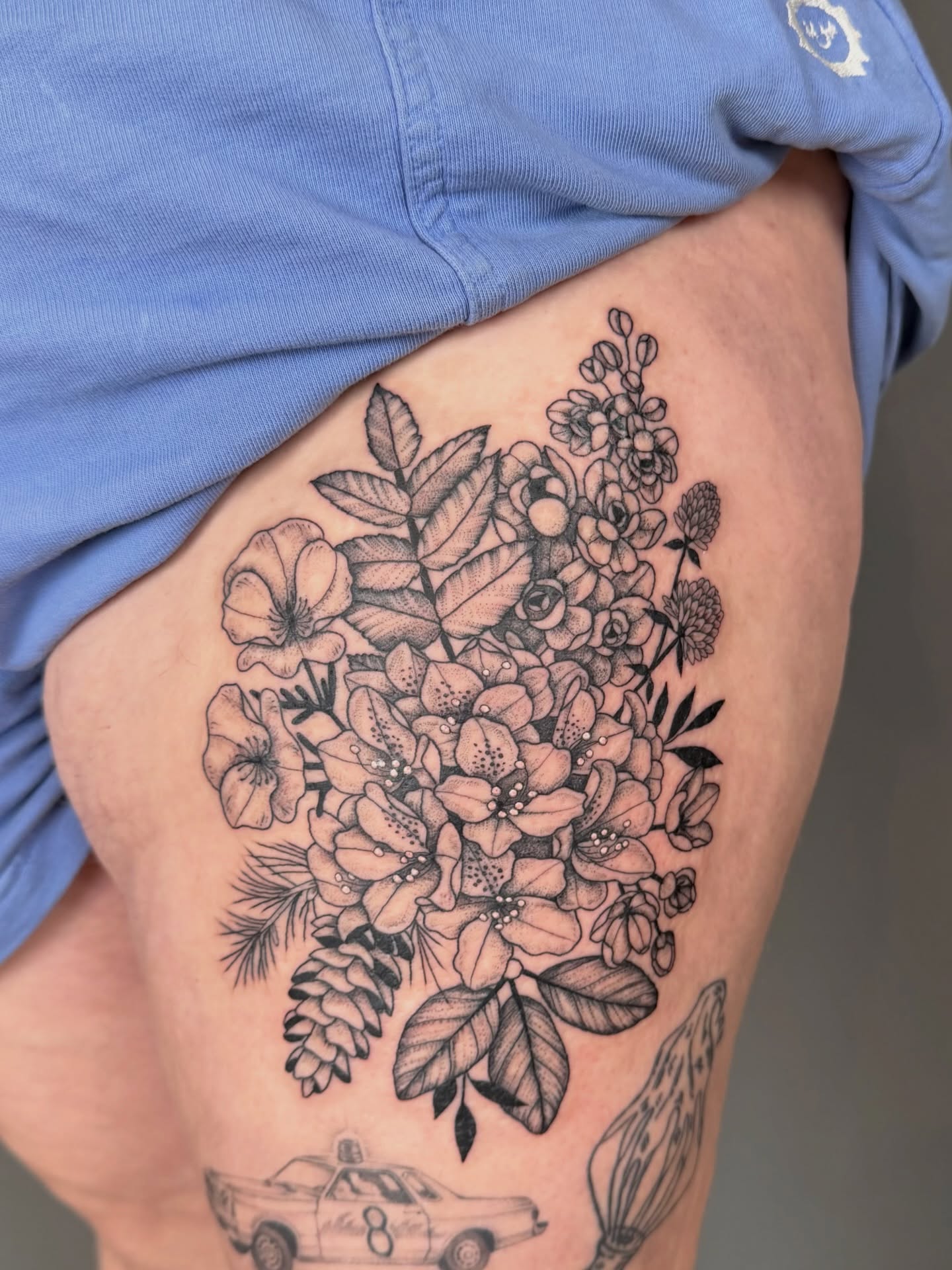 Floral bouquet black and grey tattoo on the thigh by Hannah, Portland, Oregon