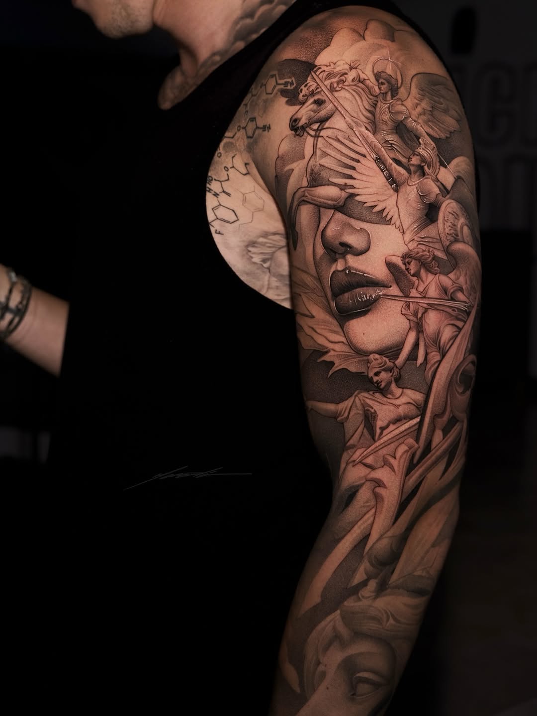 Woman's face with mythological figures realism tattoo on the upper arm by Ke$la