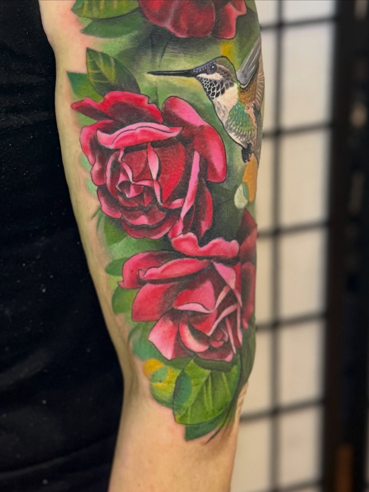 Roses and hummingbird realism tattoo on the forearm by Kevin R. Onley