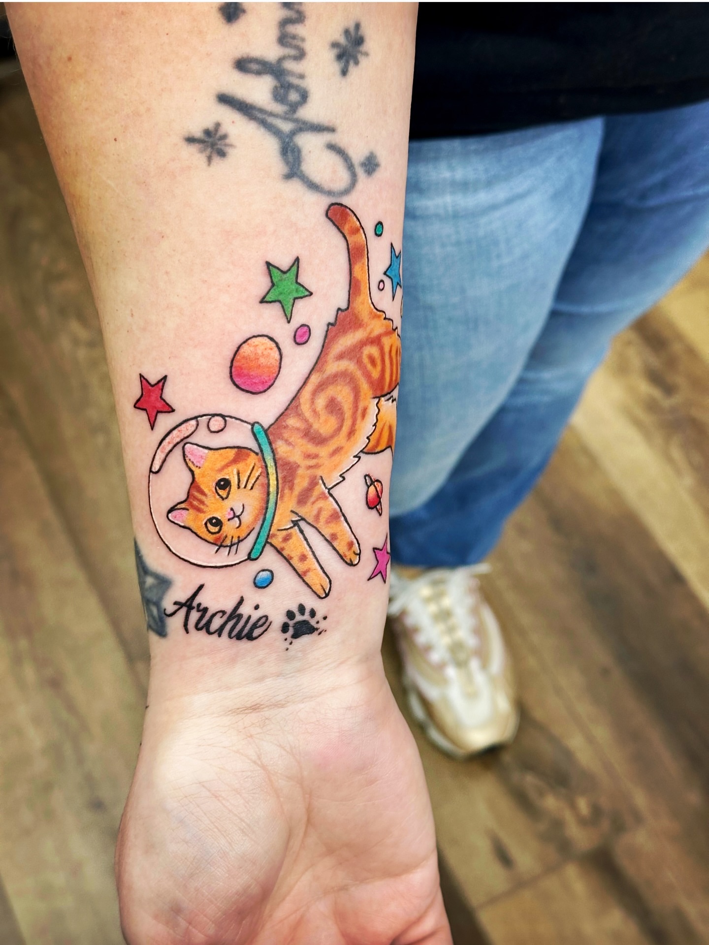 Cat in space new school tattoo on the forearm by Sk Pierce