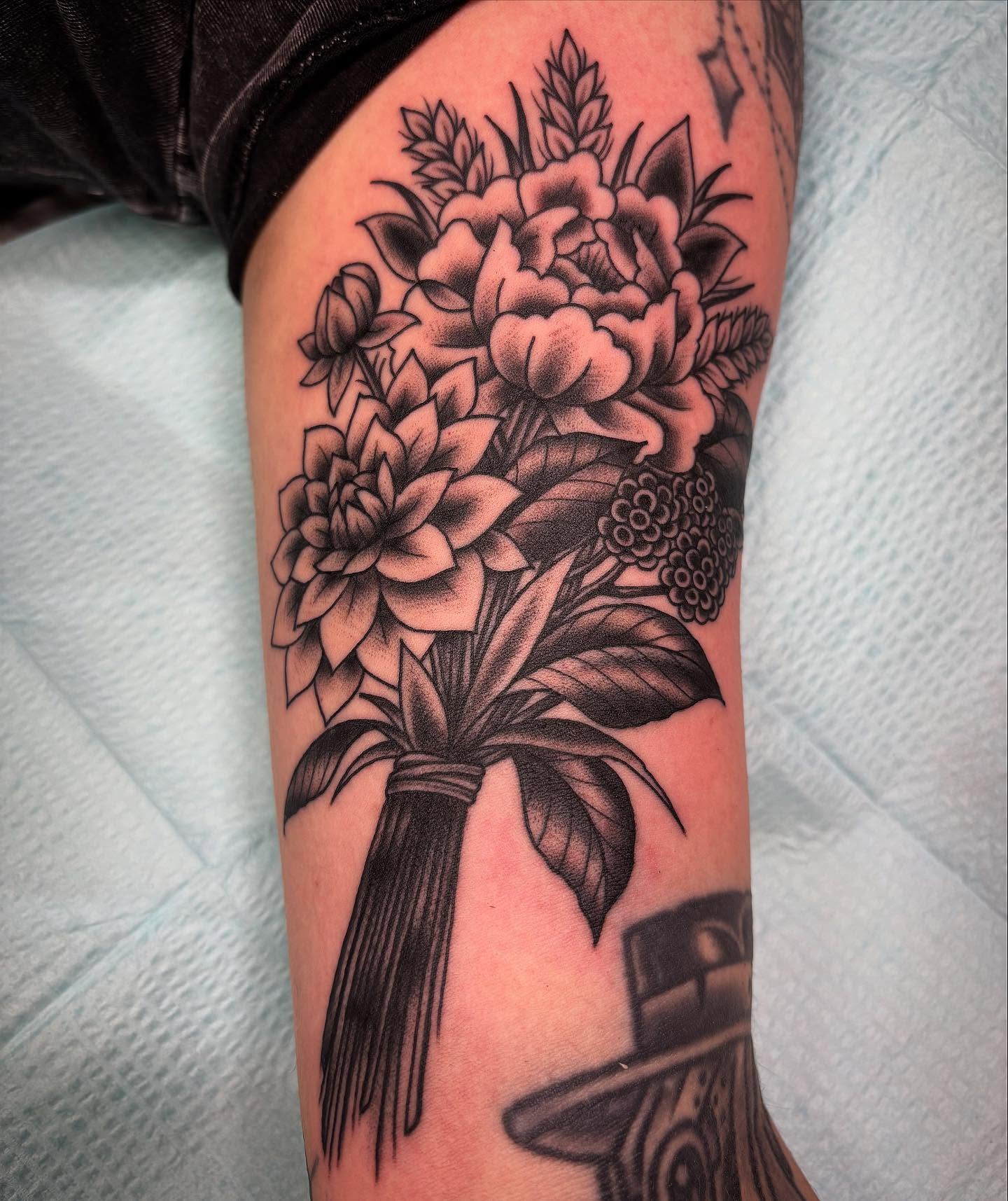 Flower bouquet black and grey tattoo on the forearm by Tom Wenzell