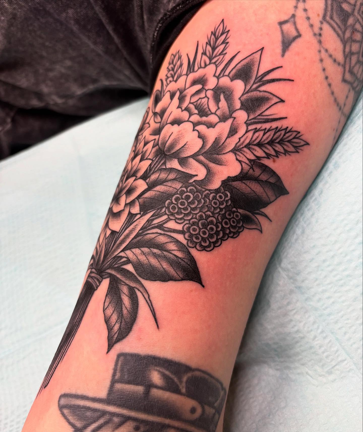 Floral bouquet black and grey tattoo on the forearm by Tom Wenzell