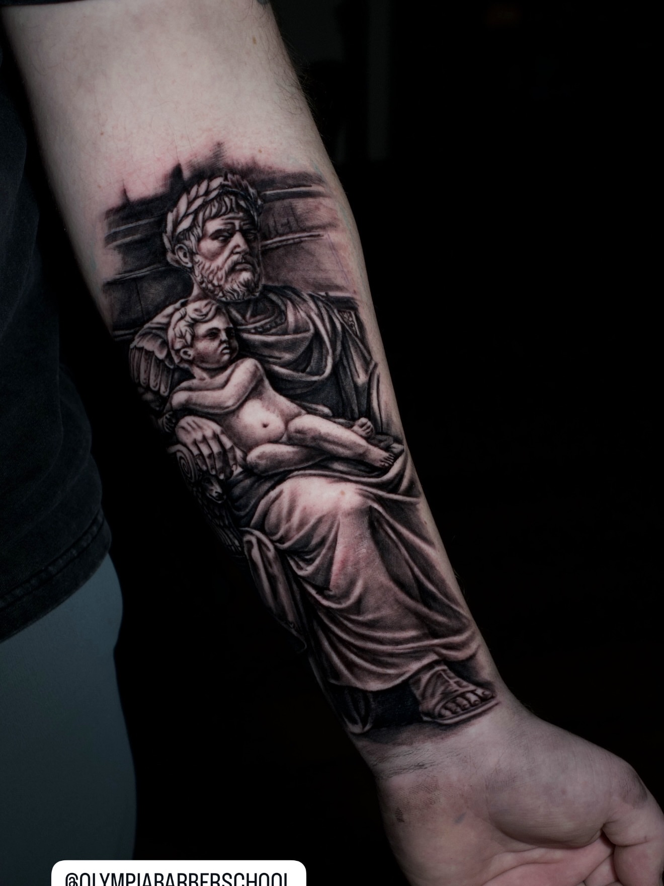 Statue of man holding child realism tattoo on the forearm by Niko Hosk Cataldo
