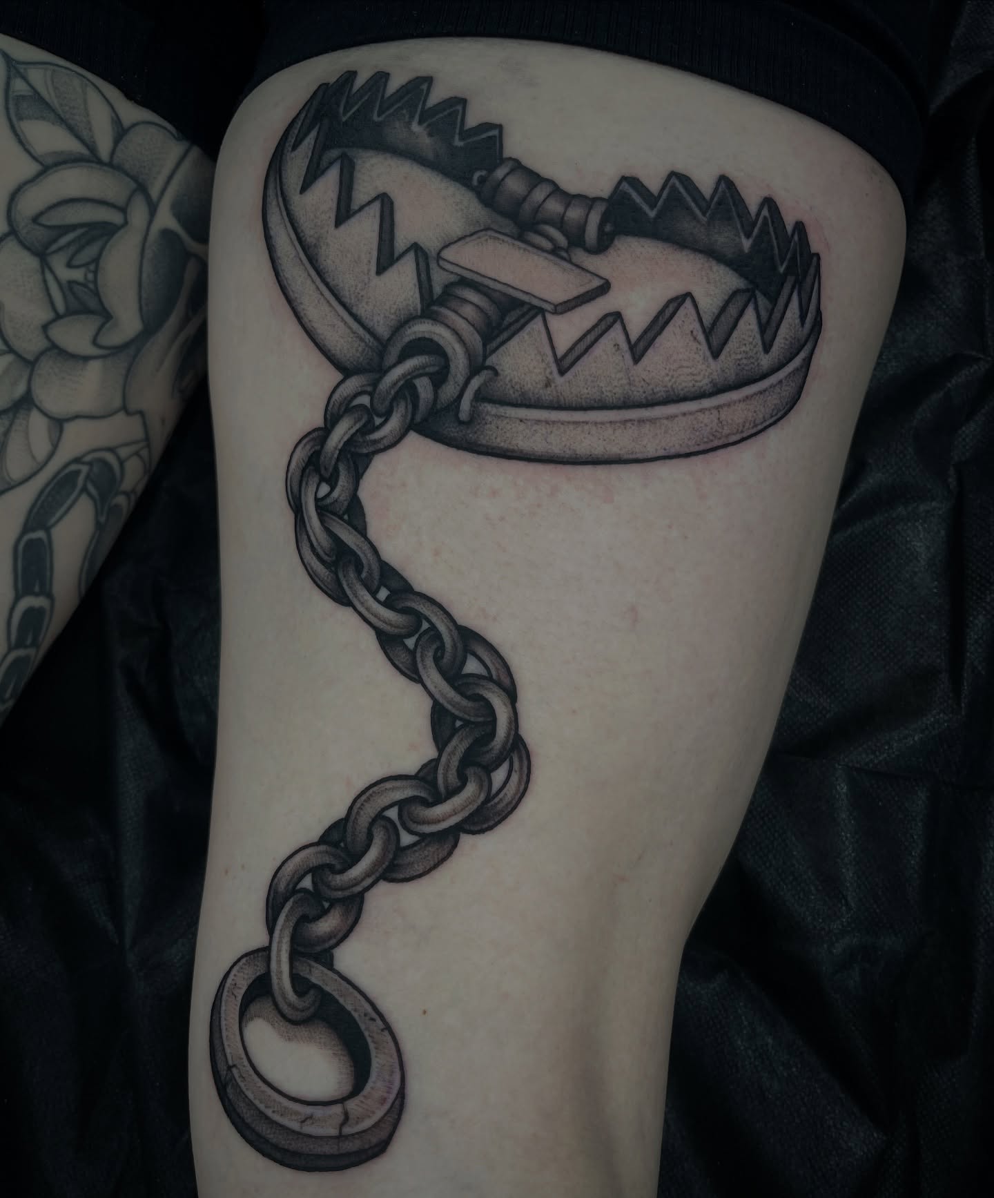 Bear trap black and grey tattoo on the forearm by Jordan Hunt