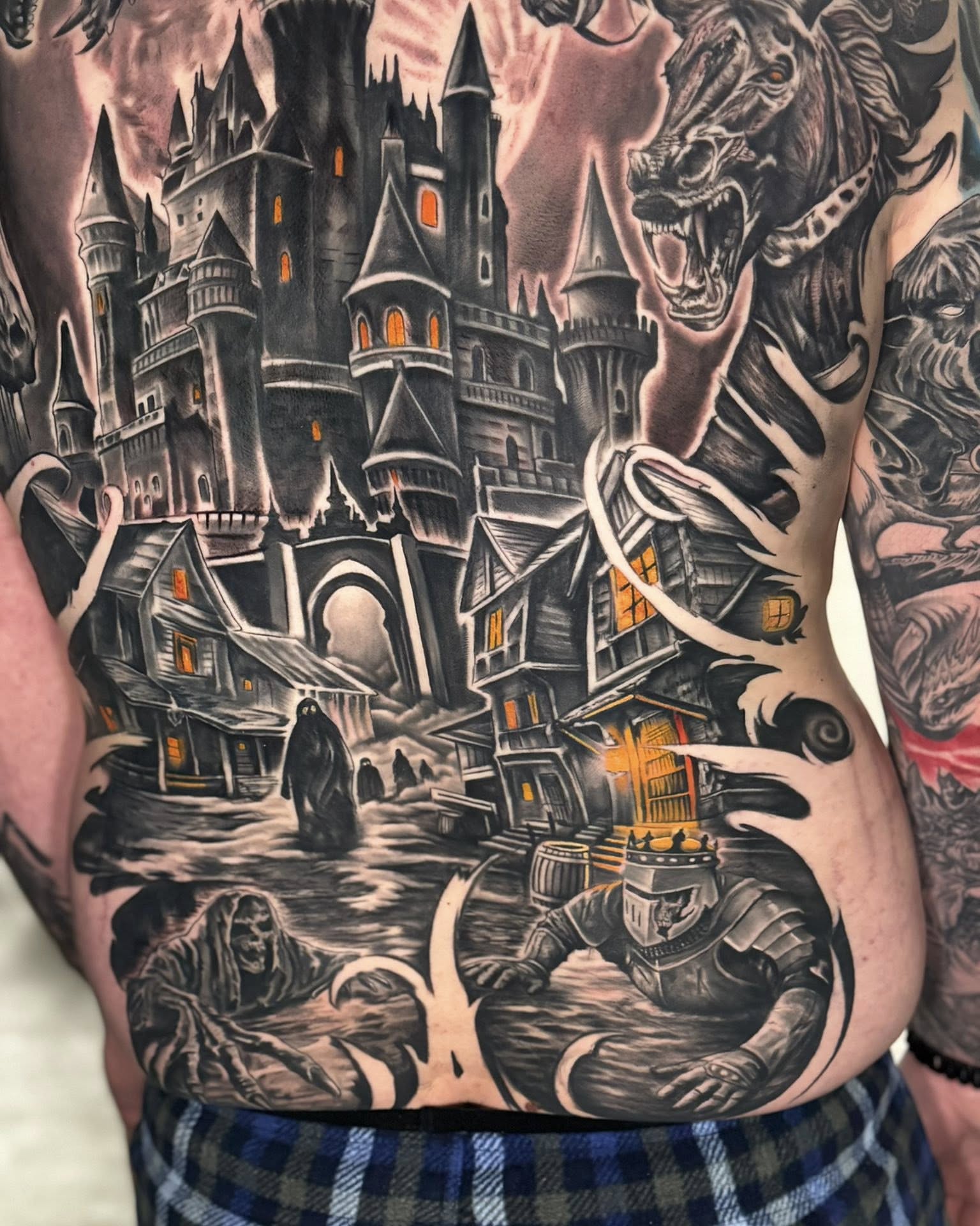 Castle and monster dark realism tattoo on the torso by Shawn Skale