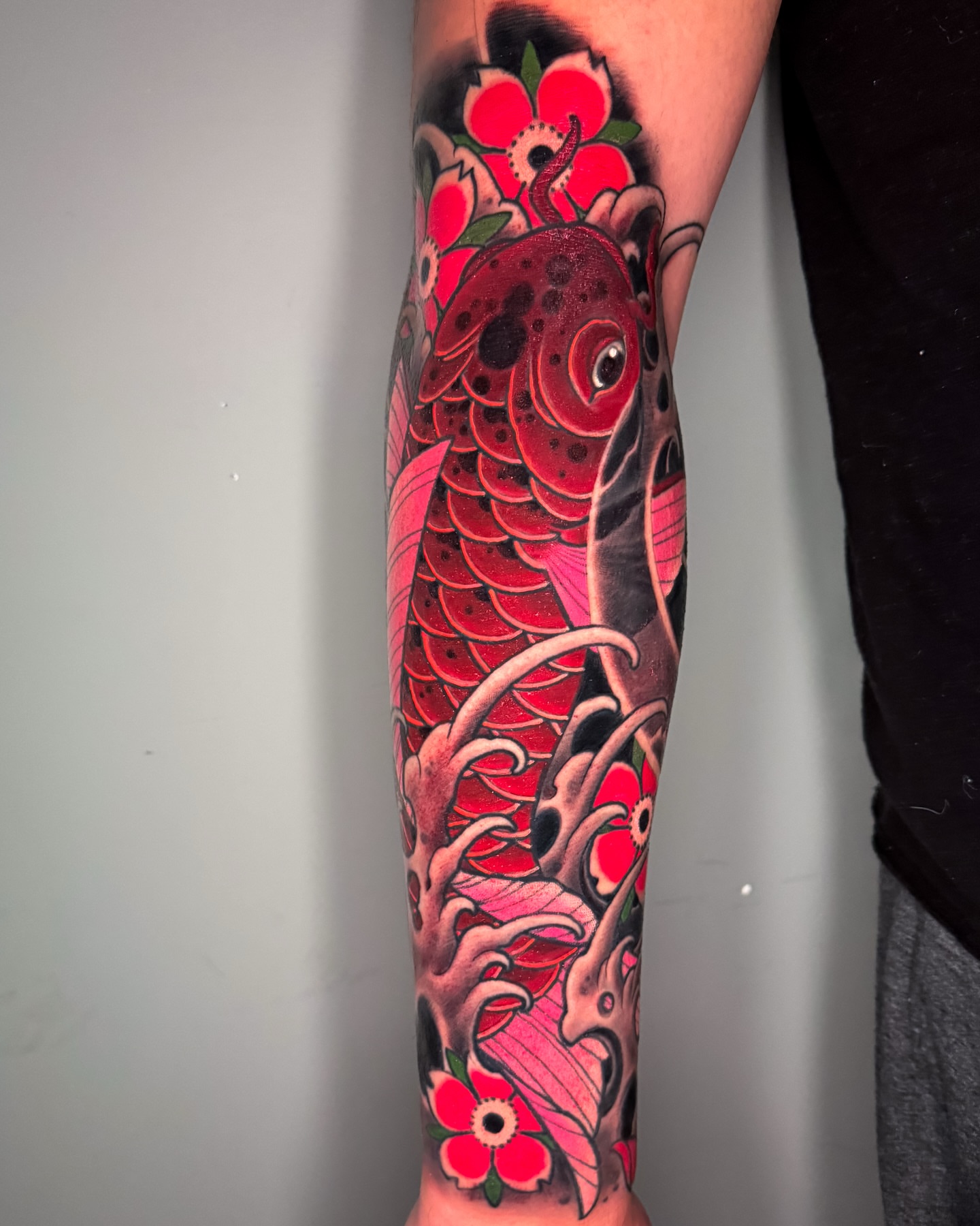 Koi fish and flowers japanese irezumi tattoo on the forearm by Austin Britt