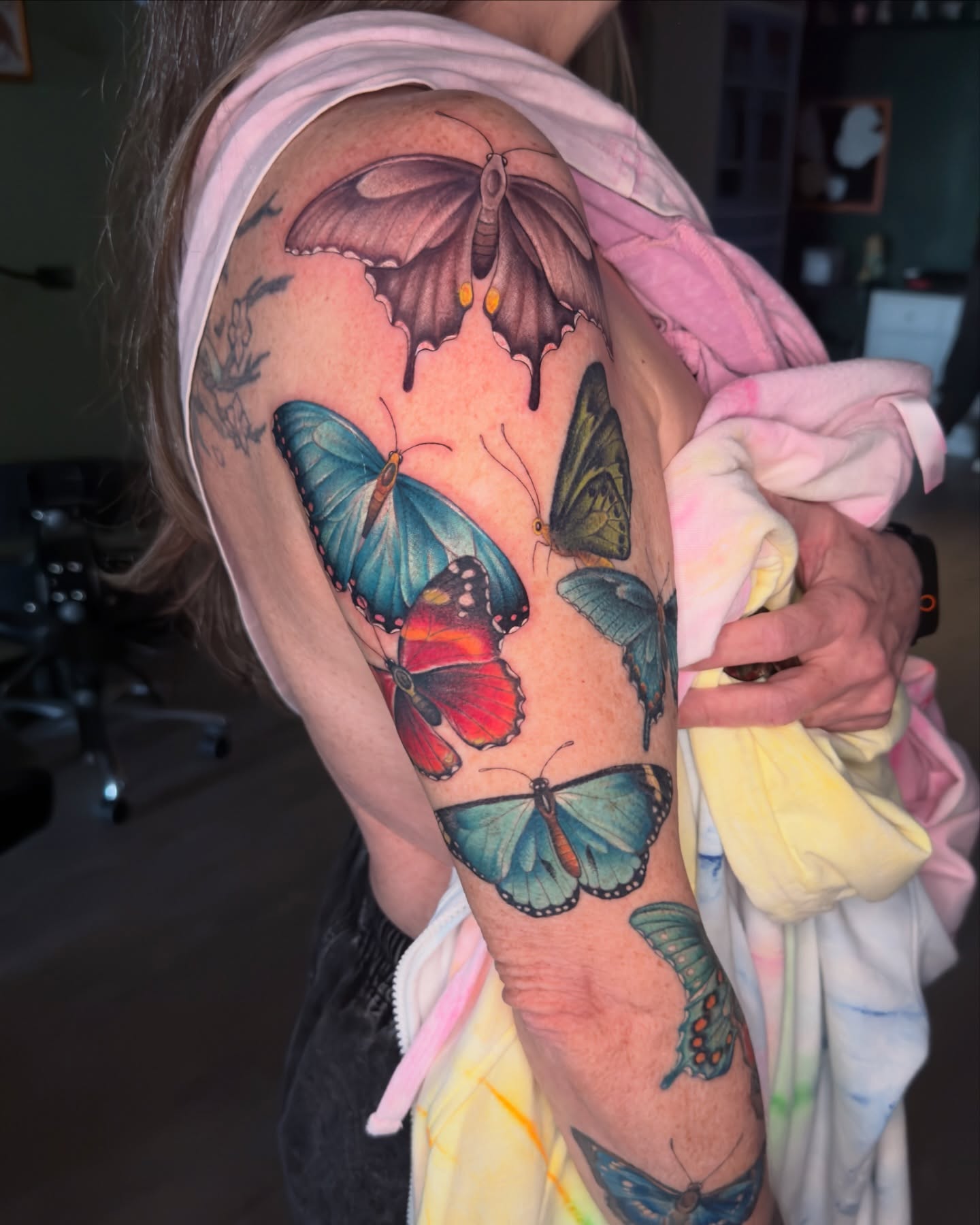 Butterflies realism tattoo on the upper arm by Nichole Lorence