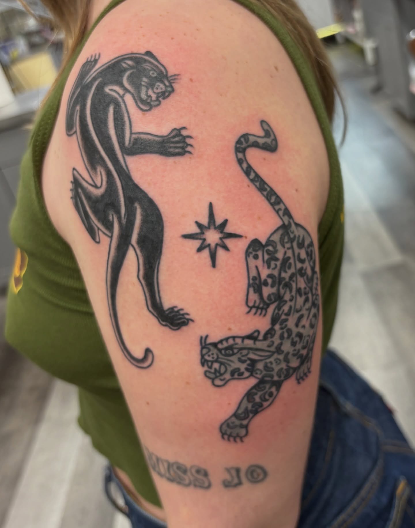 Panthers black and grey tattoo on the shoulder by Aysia Mankin-Wong, San Francisco, California