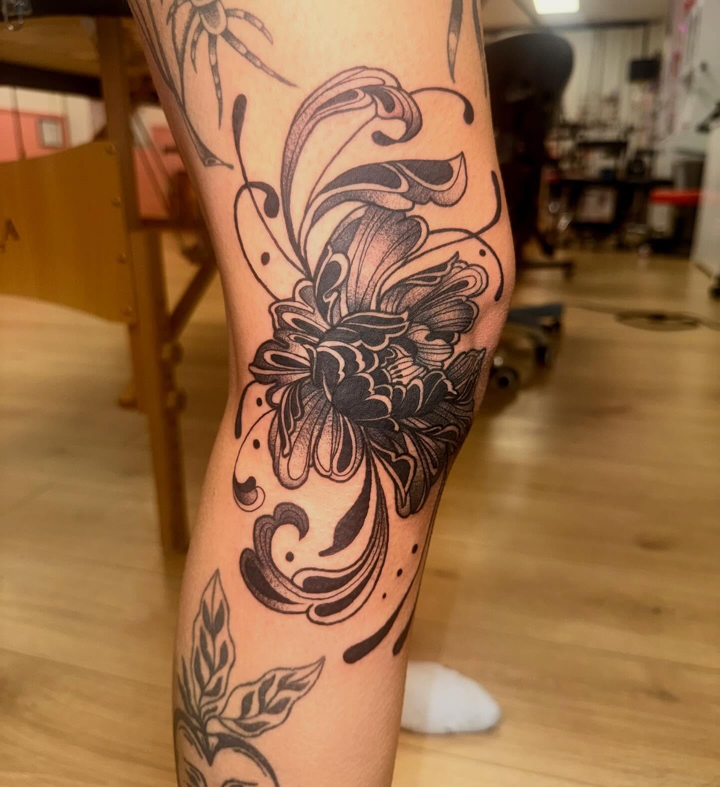 Floral design black and grey tattoo on the forearm by Laurito