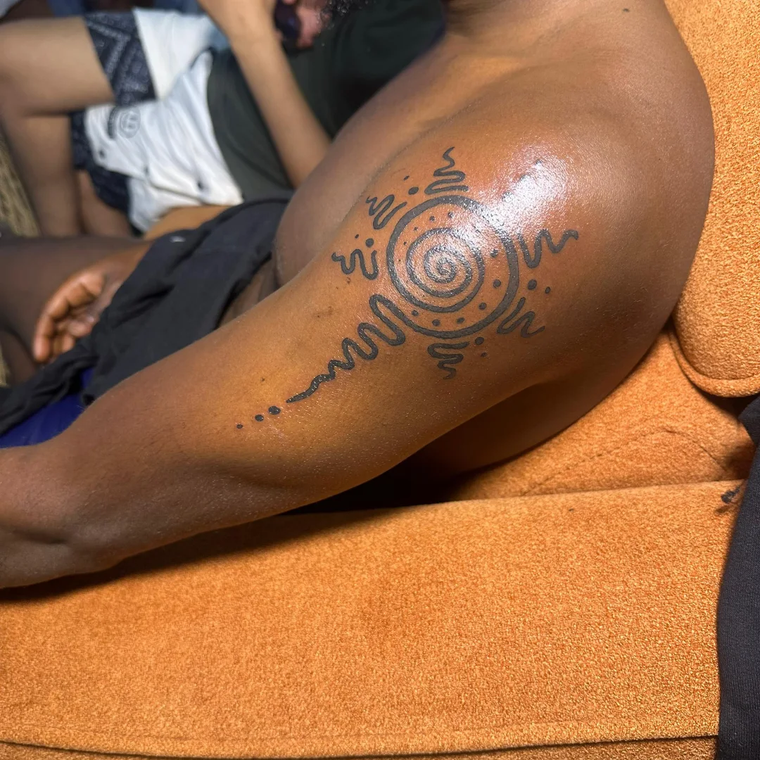 Spiral dotwork tattoo on the upper arm by Mwangaza Bodyworks, Uthiru, Nairobi Area, Kenya