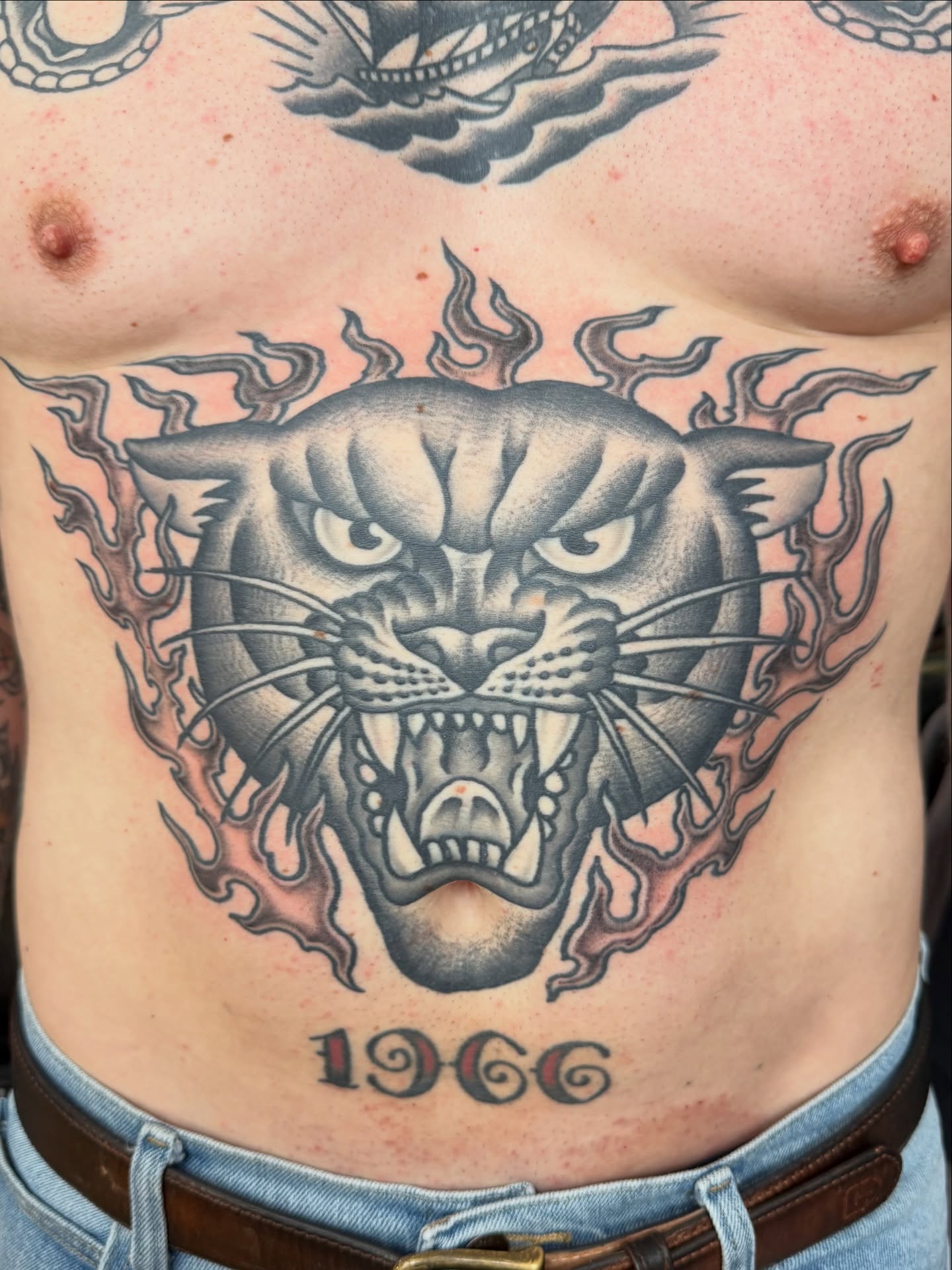 Panther black and grey tattoo on the chest by Zak Colburn