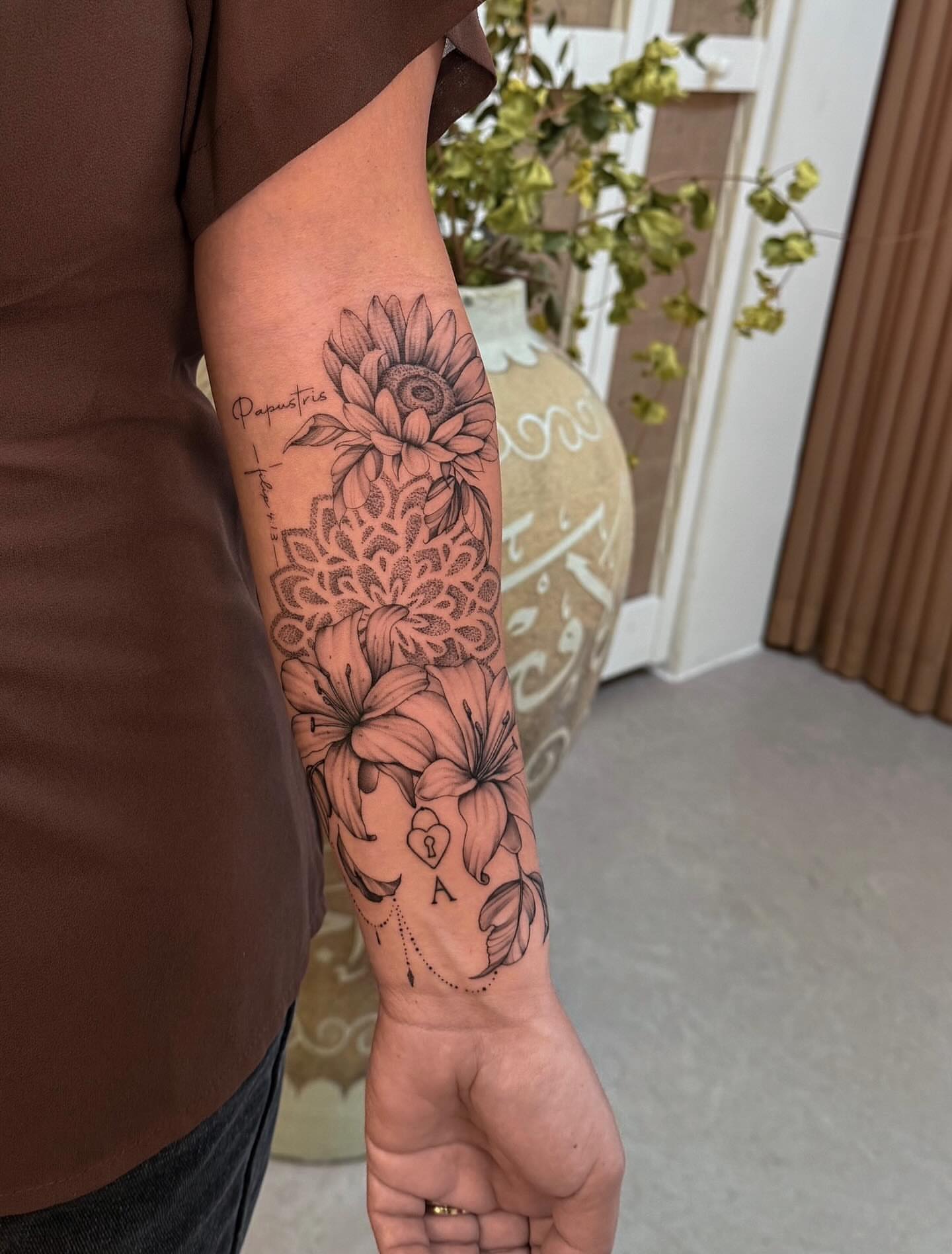 Floral arrangement realism tattoo on the forearm by Christian Guerrero