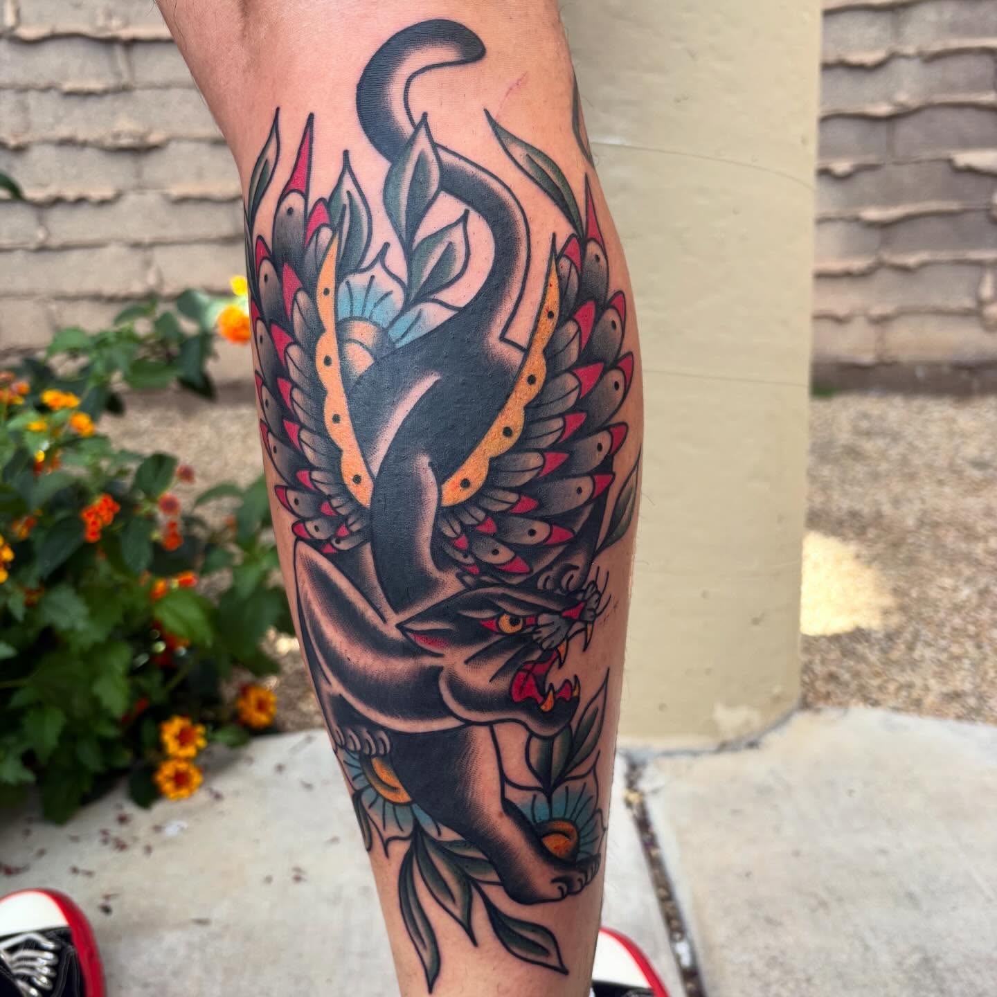 Panther and floral American traditional tattoo on the calf by Allyson Monique