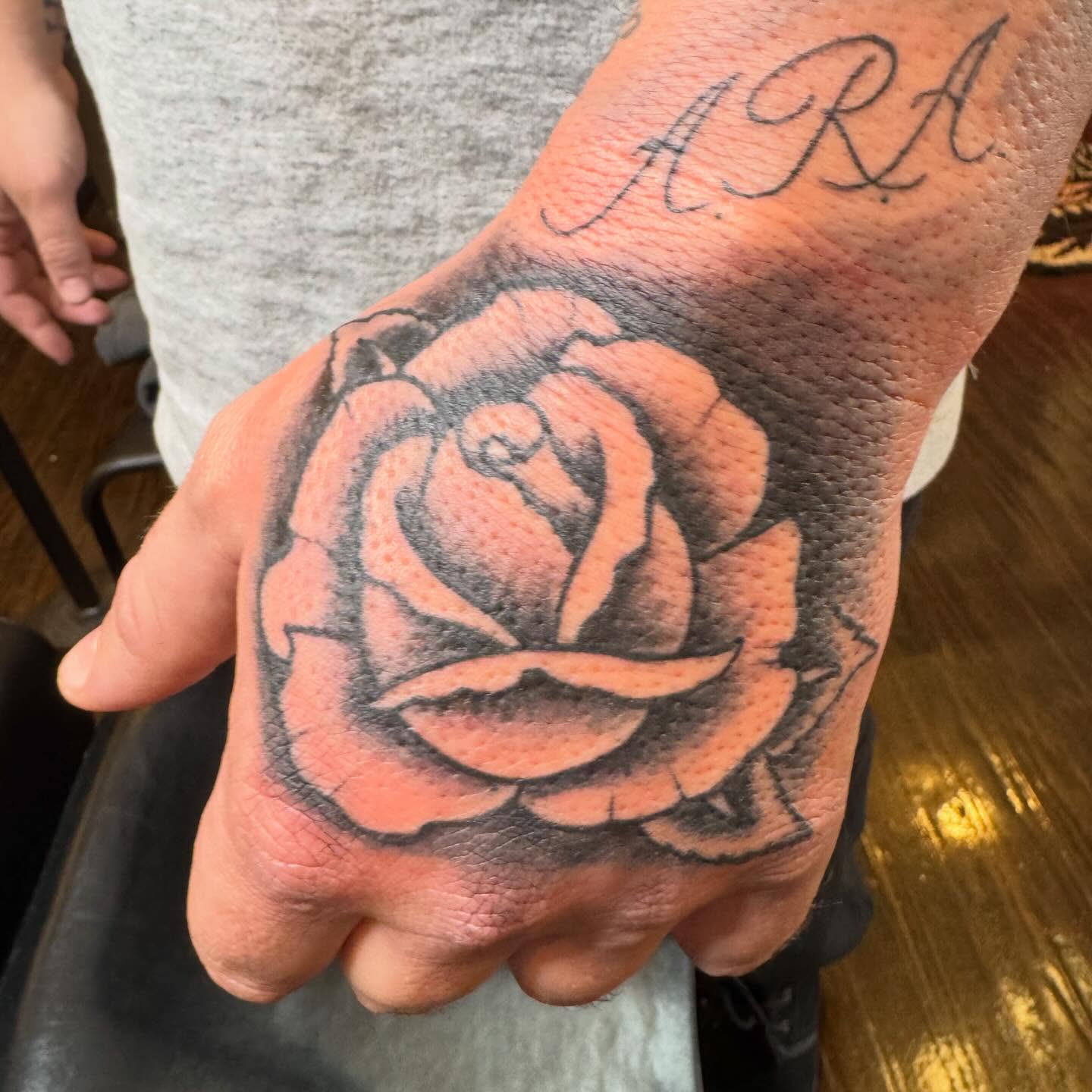 Rose black and grey tattoo on the hand by Bob Lindell Tattoos