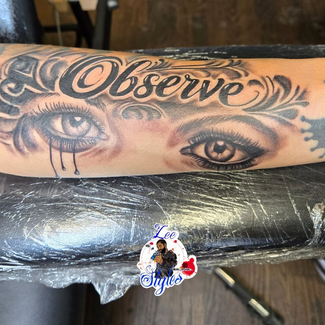Eyes and lettering tattoo on the forearm by Lee Styles π¨