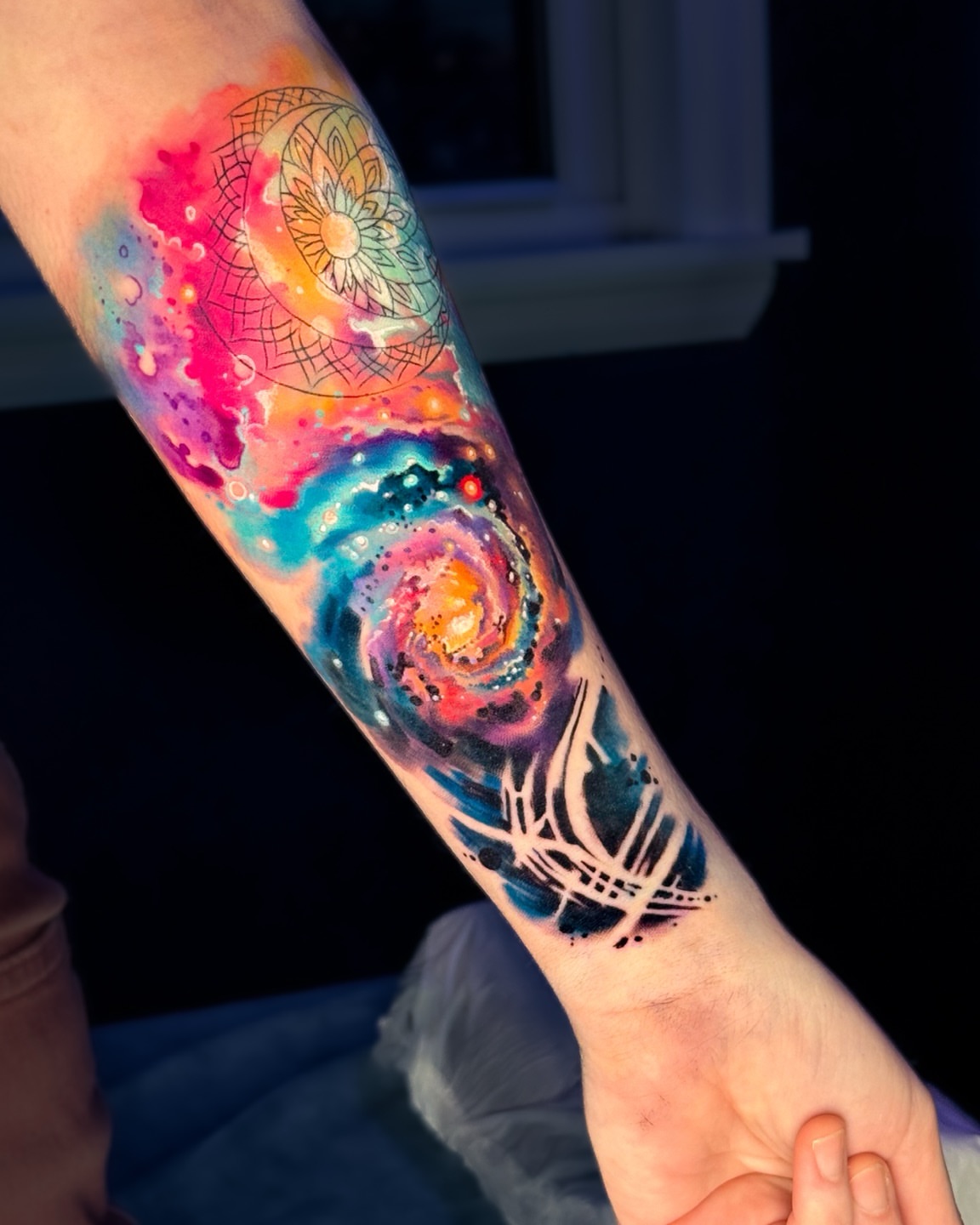 Galaxy watercolor tattoo on the forearm by Amy Zager