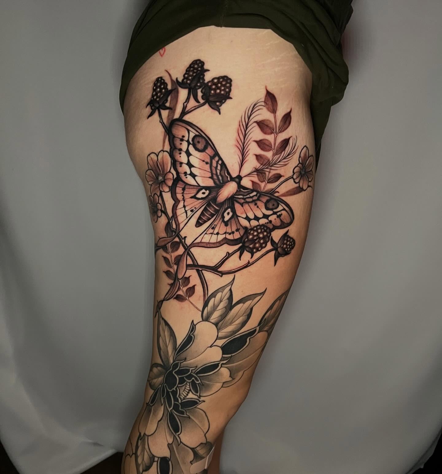 Butterfly and floral realism tattoo on the thigh by Joi Bailey, Denton, Texas