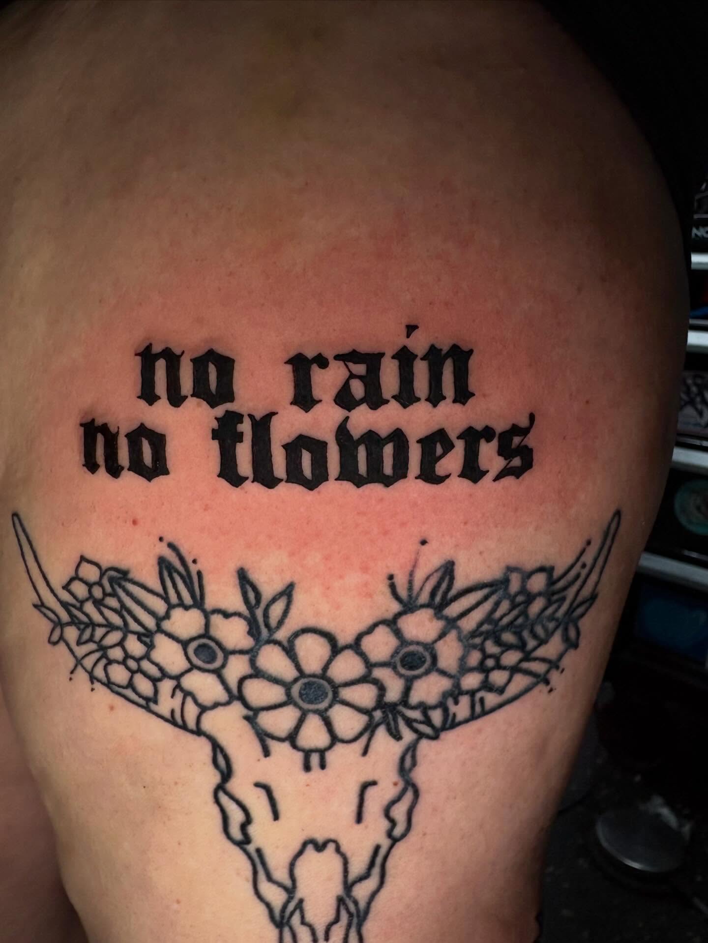 No rain no flowers black and grey tattoo on the shoulder by Jenna Clayton