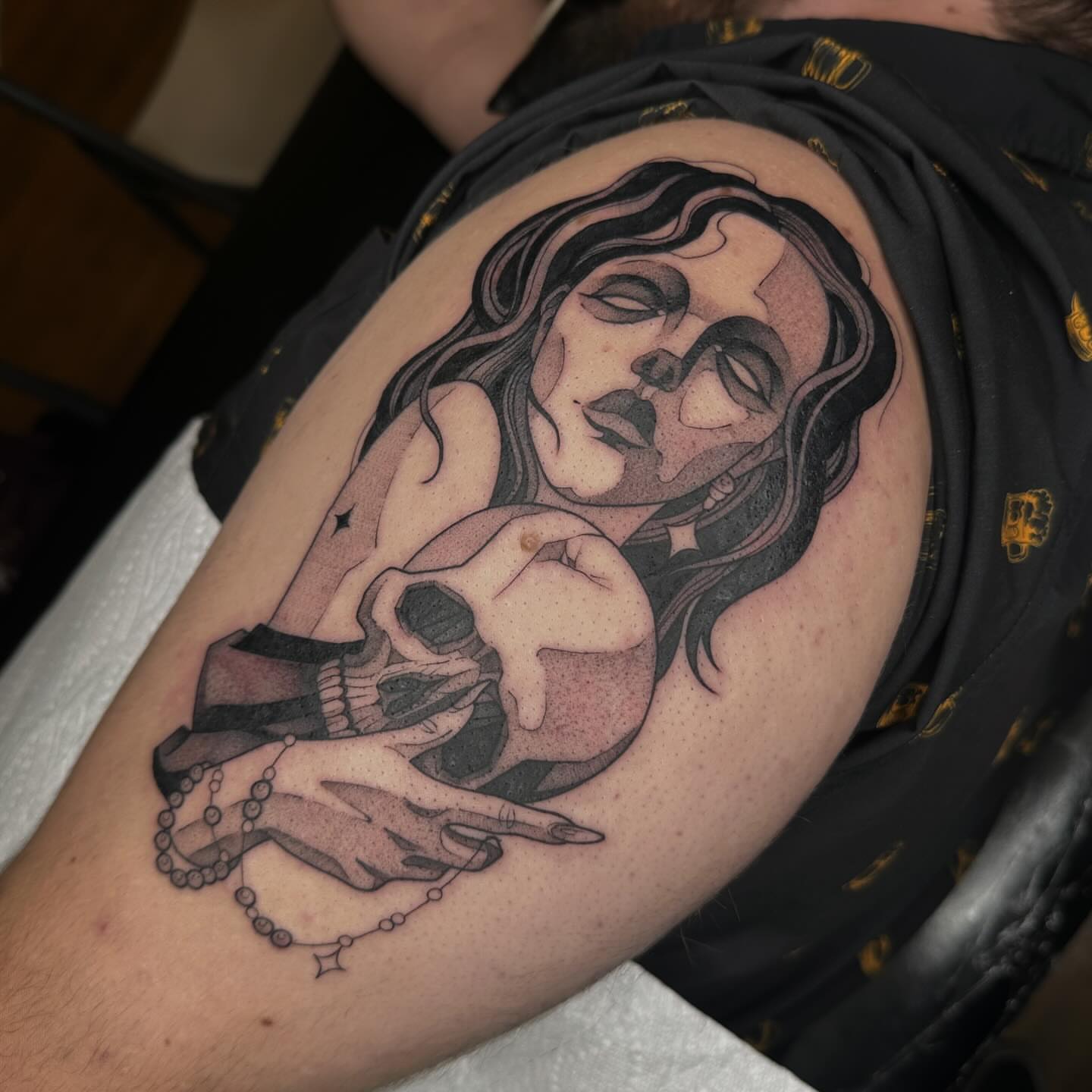 Woman with skull realism tattoo on the upper arm by Aleksandra