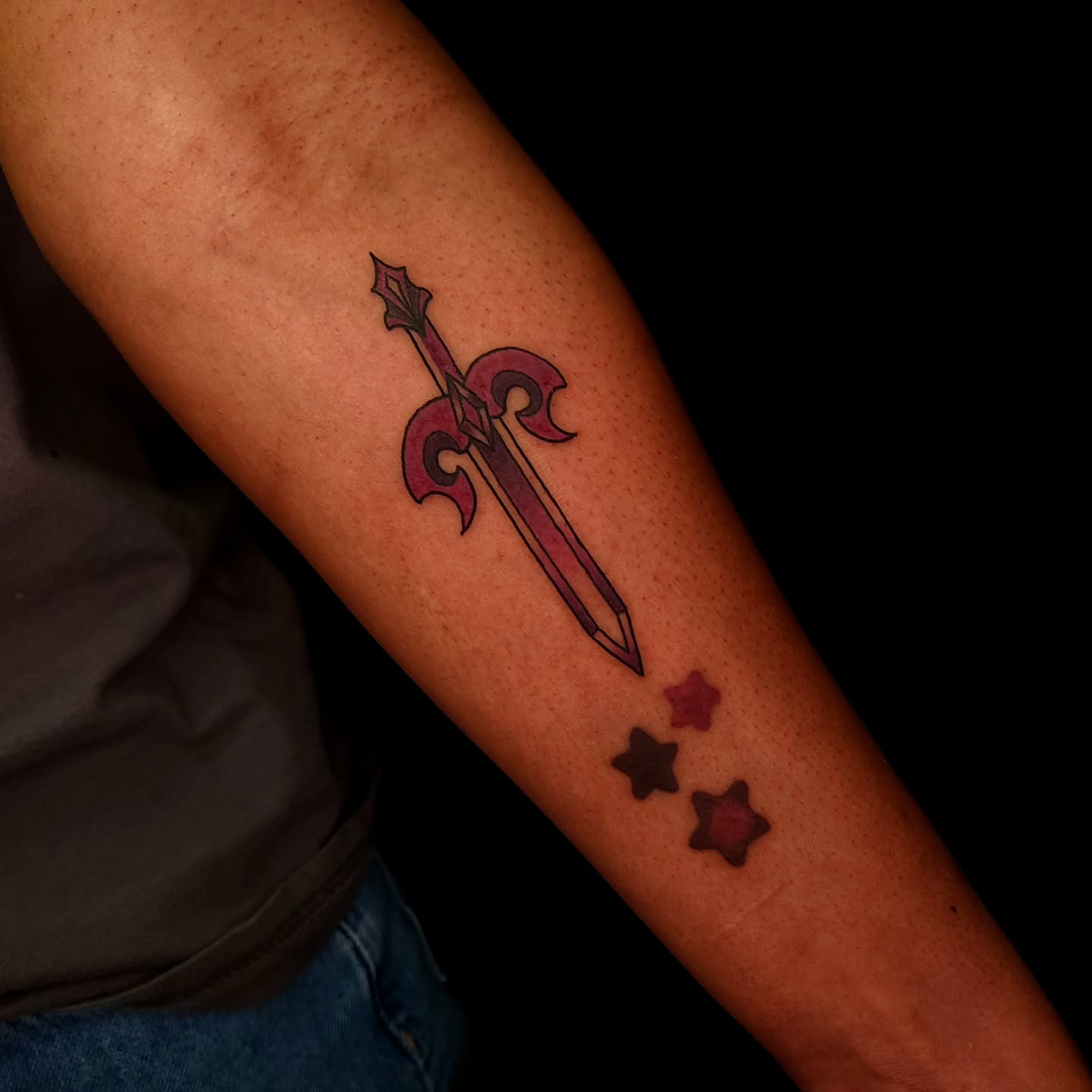 Sword and fleur-de-lis neo-traditional tattoo on the forearm by Sheena Yu-Hsin Wood