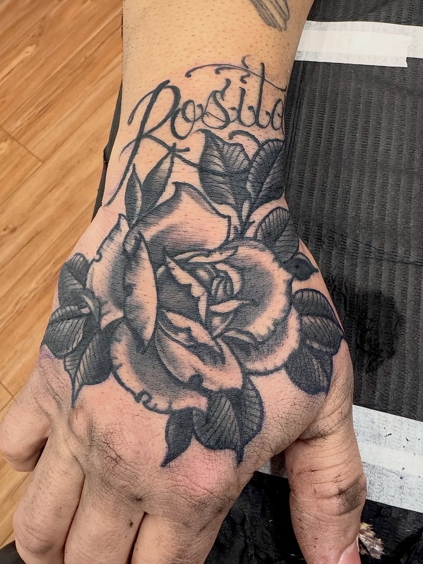 Rose black and grey tattoo on the hand by Brian DiCola Tattooer