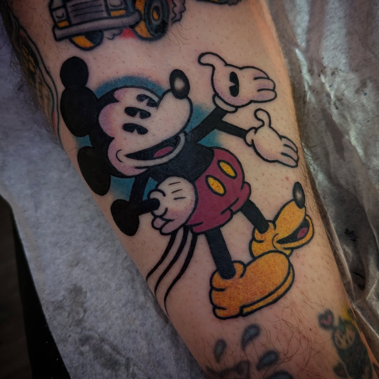 Mickey mouse and pluto American traditional tattoo on the forearm by Ryan Slegel