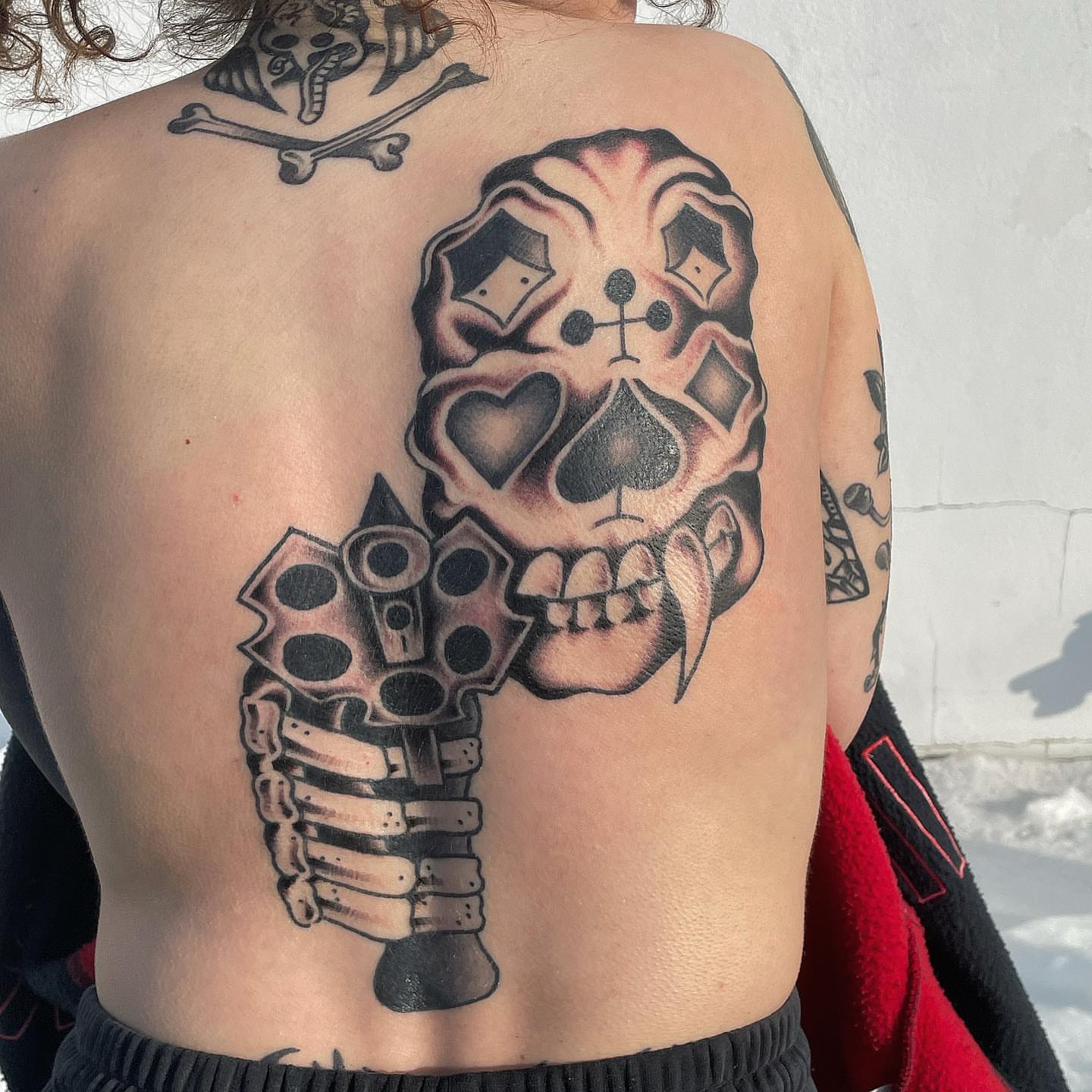 Skull and playing cards American traditional tattoo on the back by Nicholas M. Passeri