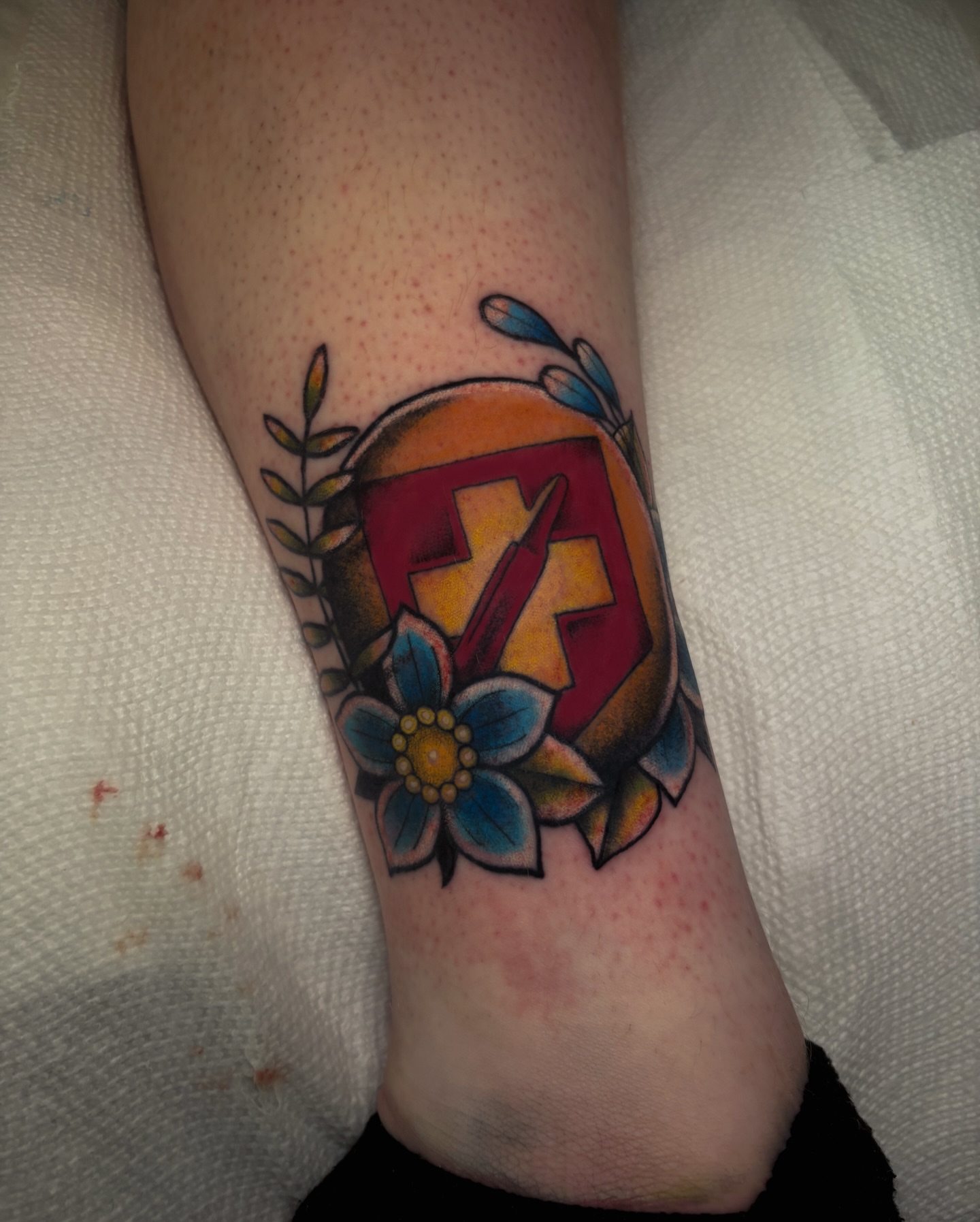 Cross and flower American traditional tattoo on the forearm by Sal