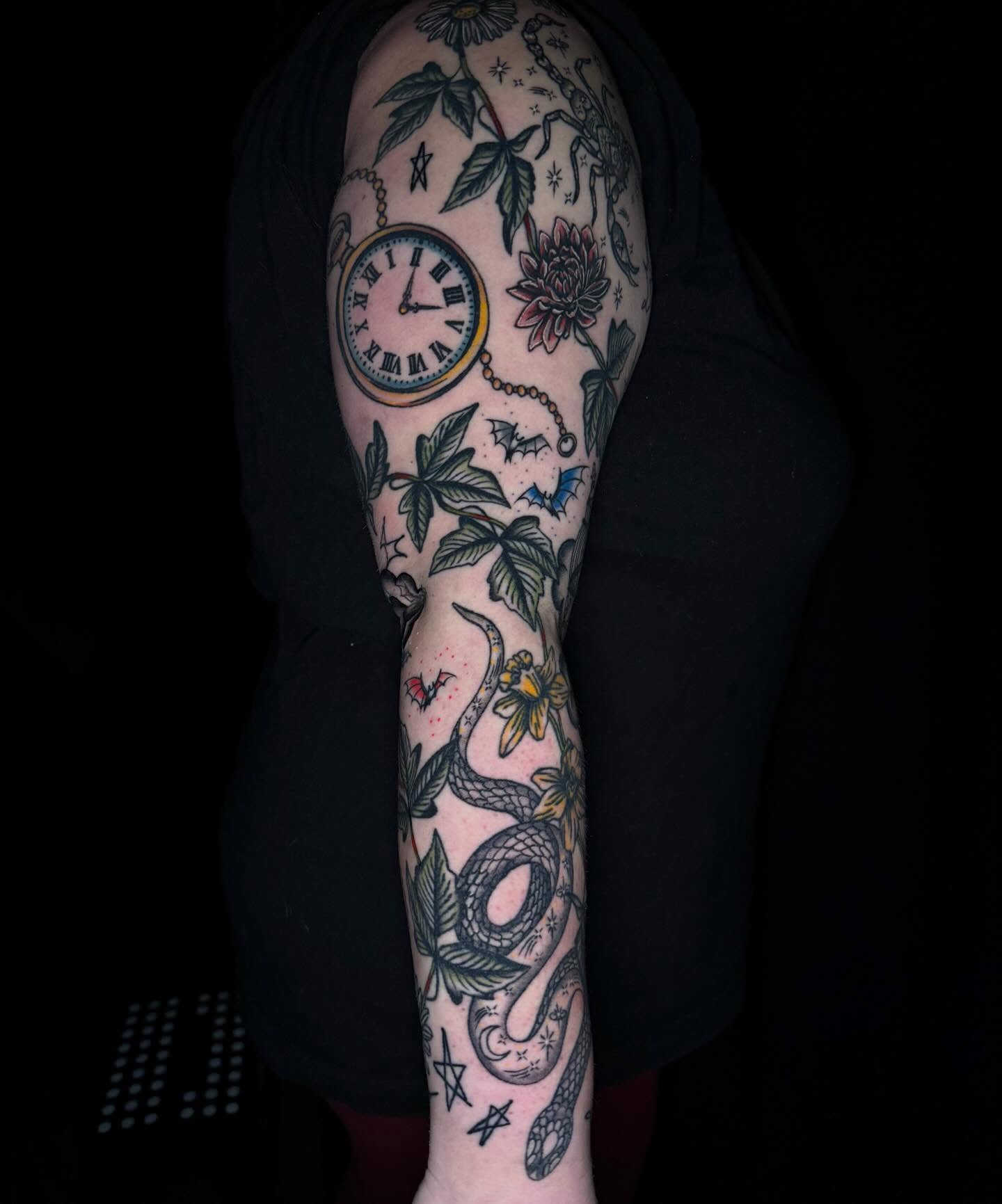 Clock and botanicals American traditional tattoo on the forearm by Mallory Brown