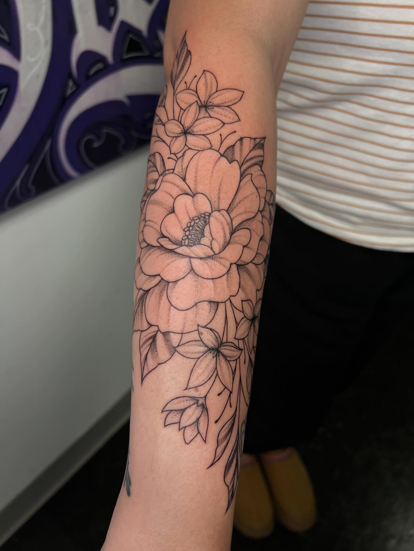 Floral bouquet black and grey tattoo on the forearm by San Diego Fineline Black & Grey Tattoo Artist