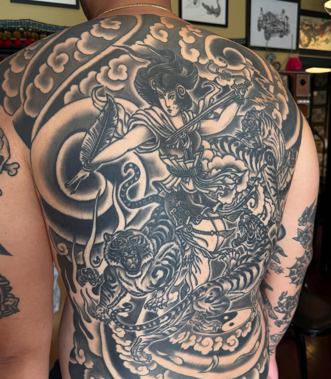 Woman fighting tigers with clouds Japanese tattoo on the back by Ross K. Jones Tattoos, San Francisco, California
