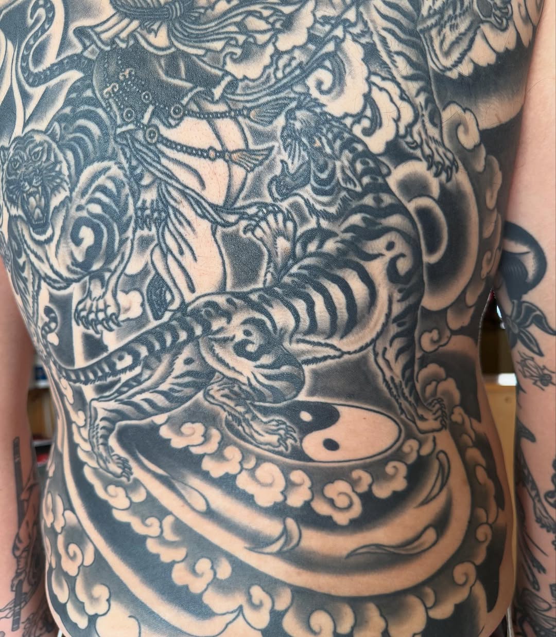 Tigers and clouds with yin yang Japanese tattoo on the back by Ross K. Jones Tattoos, San Francisco, California
