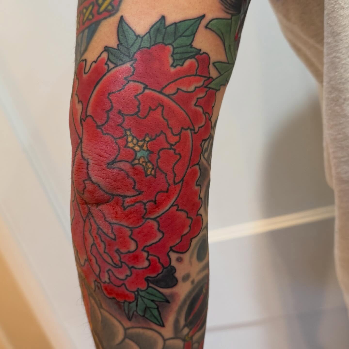 Peony American traditional tattoo on the forearm by Laura Saadati Kepper