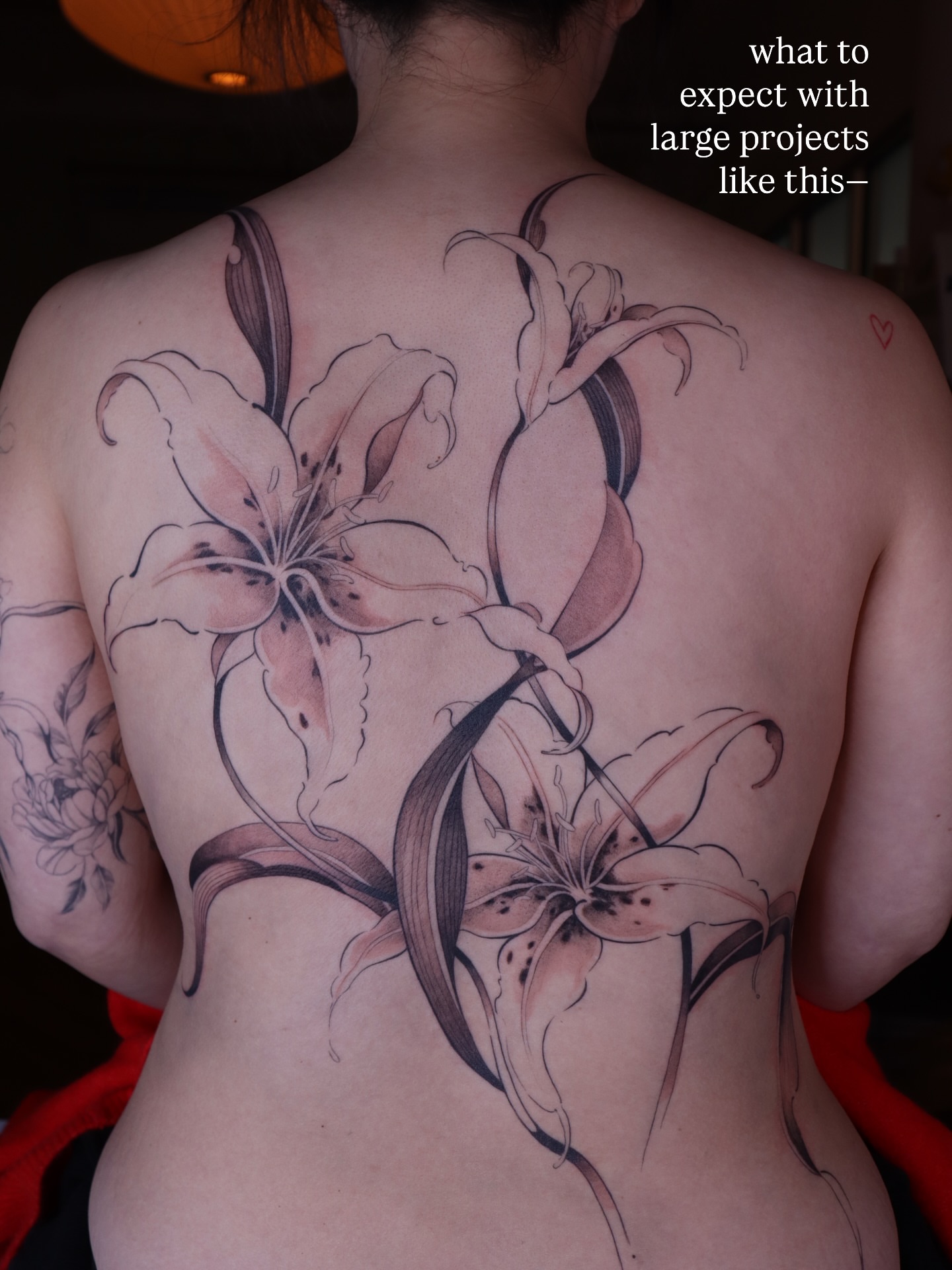 Lilies black and grey tattoo on the back by Savana Wang