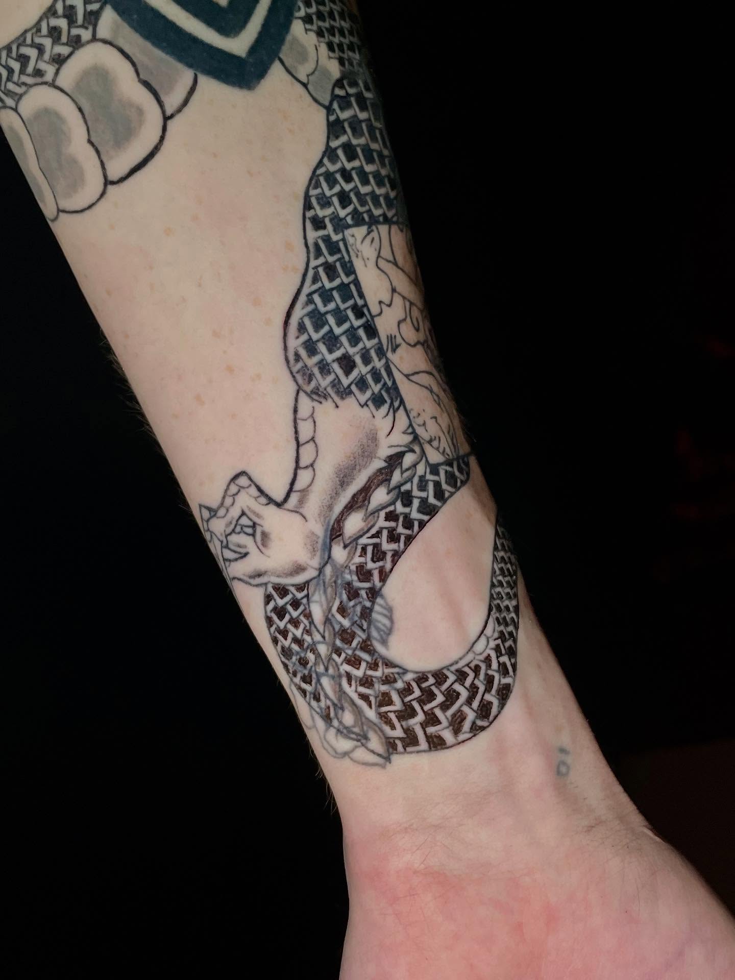 Snake black and grey tattoo on the forearm by ๐ท๐ซKevan๐๐ท