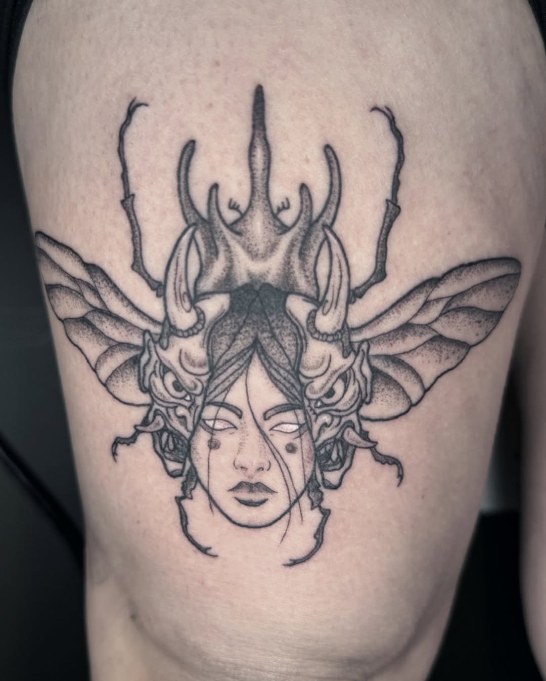 Fine line tattoo on the thigh by Tara Woods