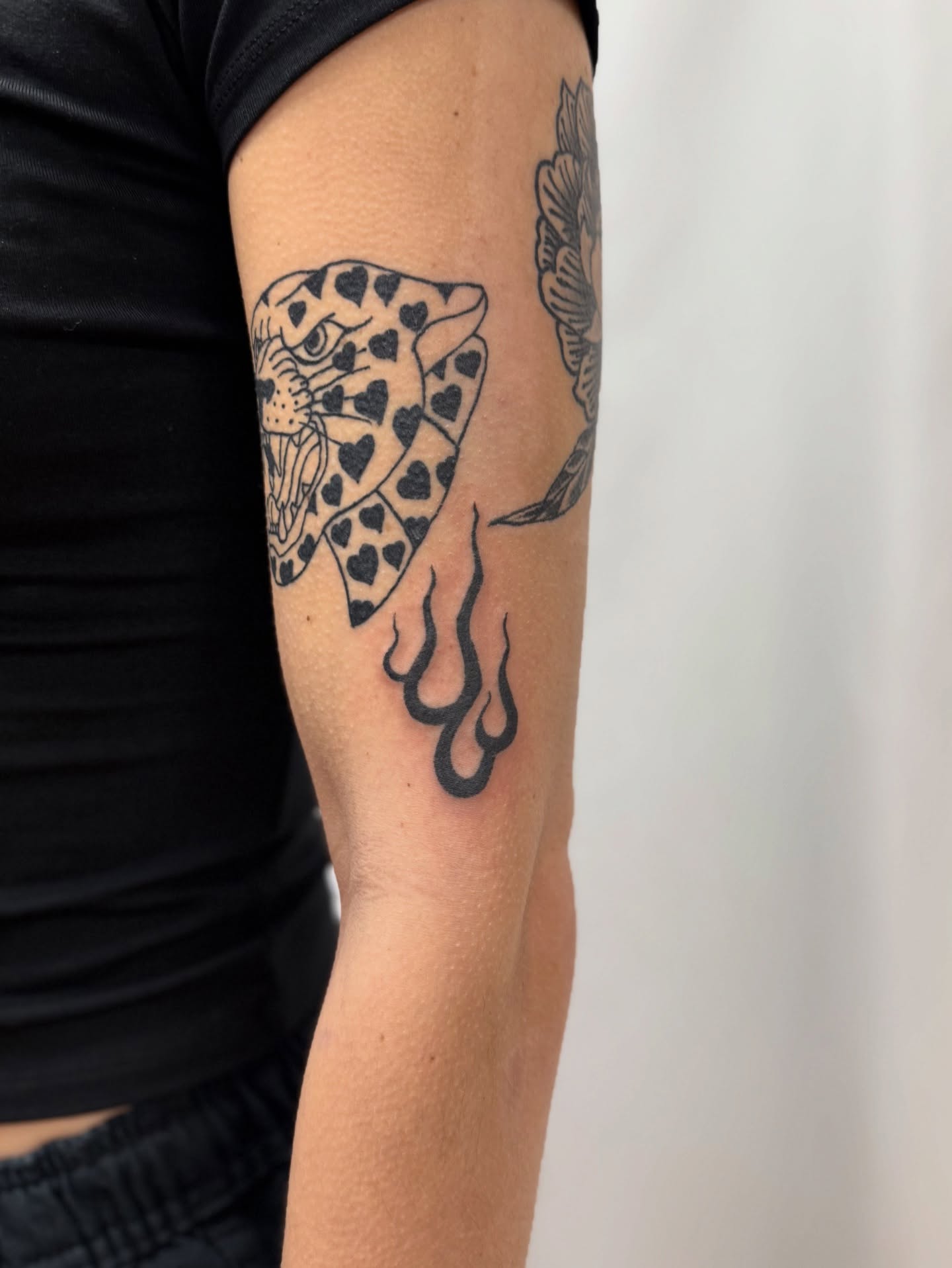 Pizza slice black and grey tattoo on the forearm by Melia Mariko