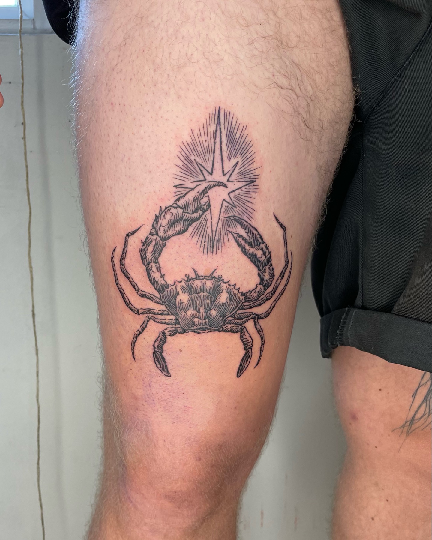 Crab black and grey tattoo on the thigh by Anh Đan