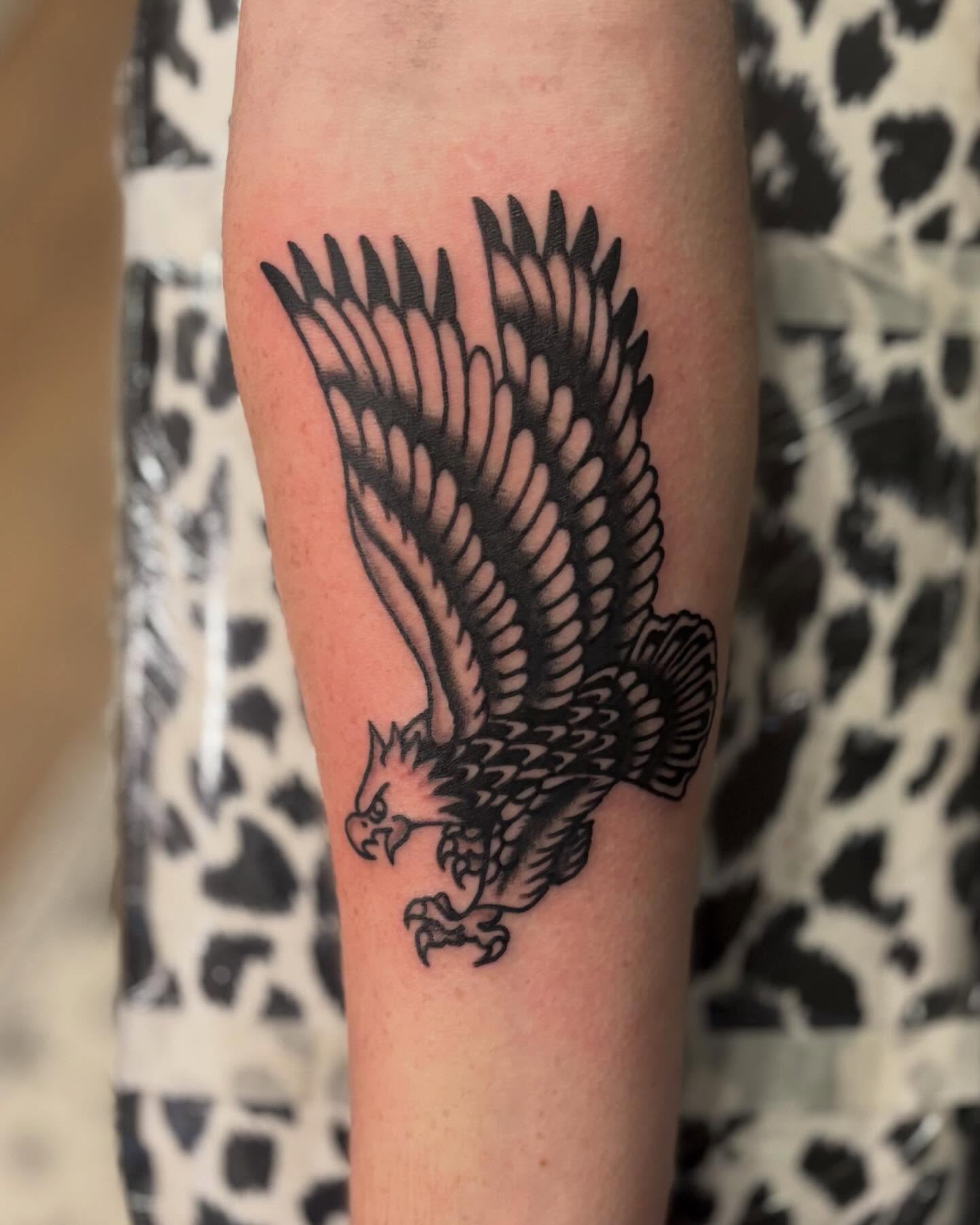 Eagle black and grey tattoo on the forearm by Tia Cave
